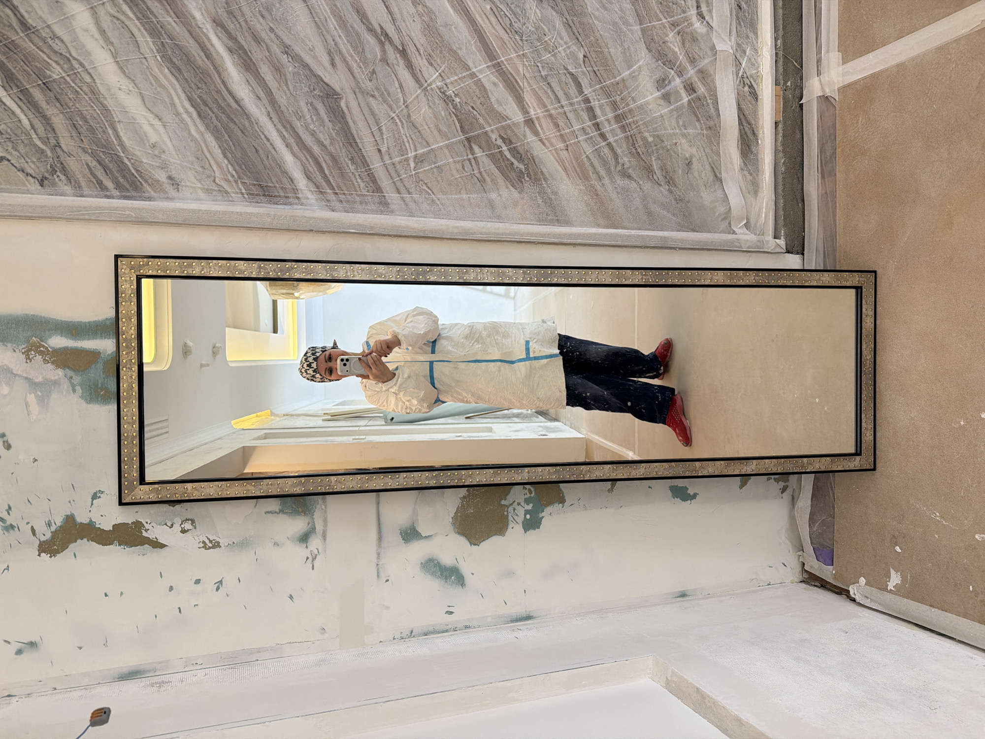 Person in protective suit takes mirror selfie in Khimki