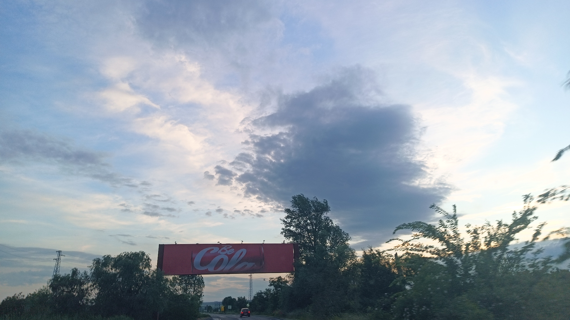 Highway journey documented near Aytos, Bulgaria with billboards, power lines