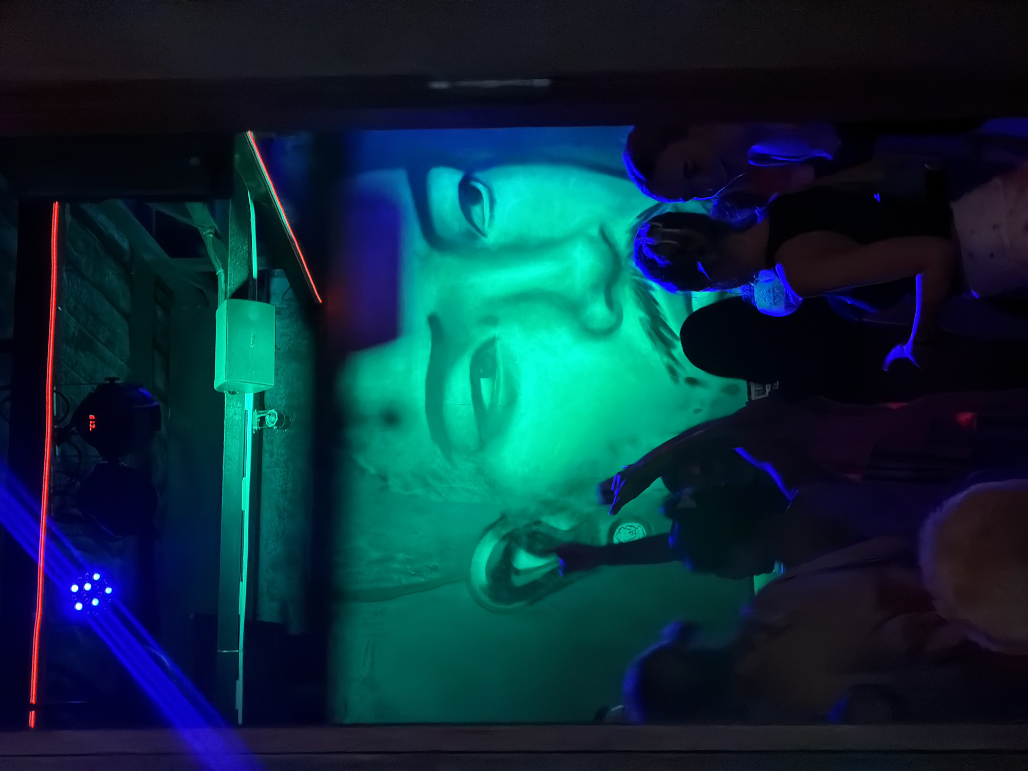 Illuminated face art installation draws patrons at Phuket nightclub