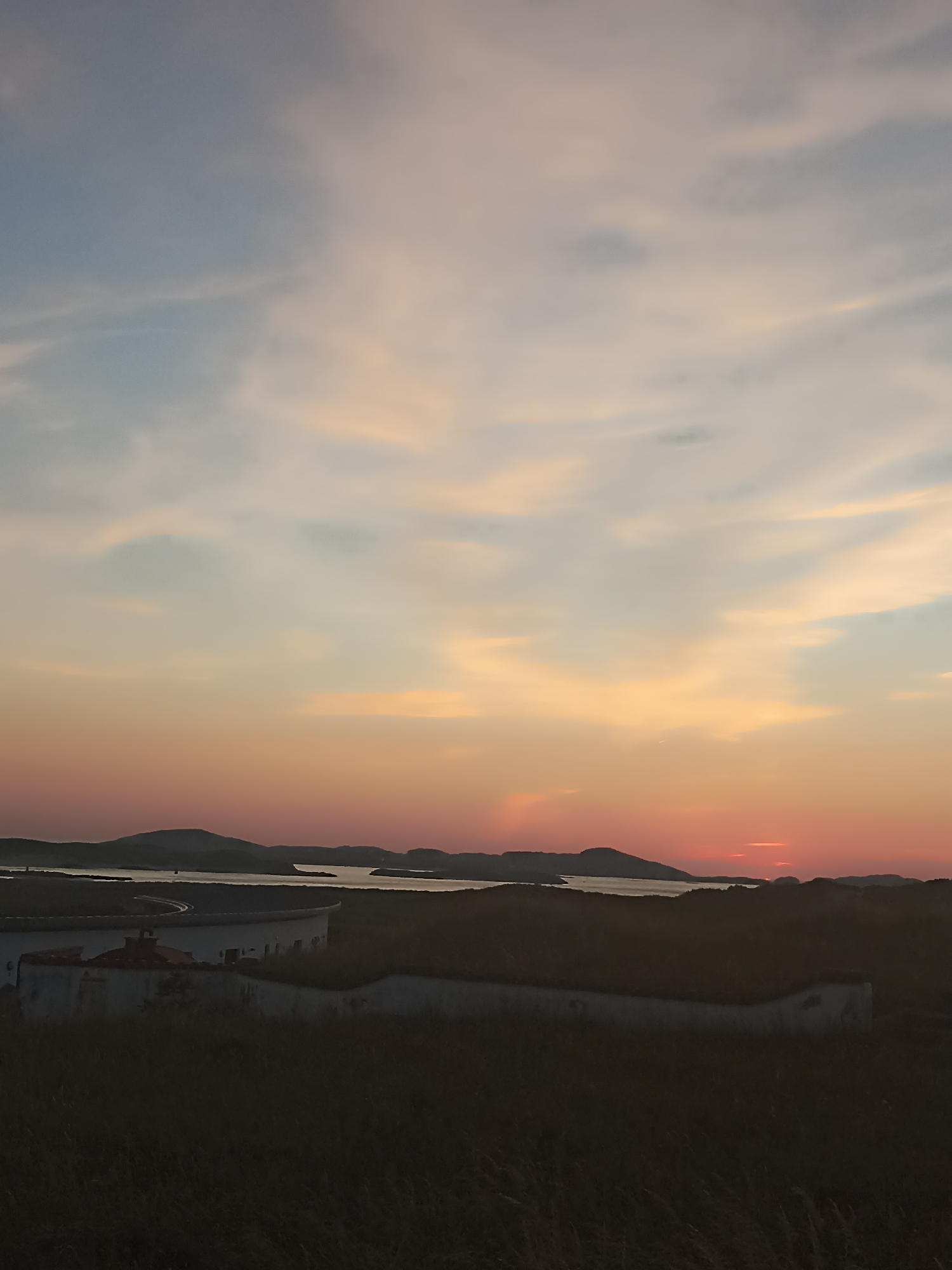 Dusk settles over an Irish coastal village and shoreline