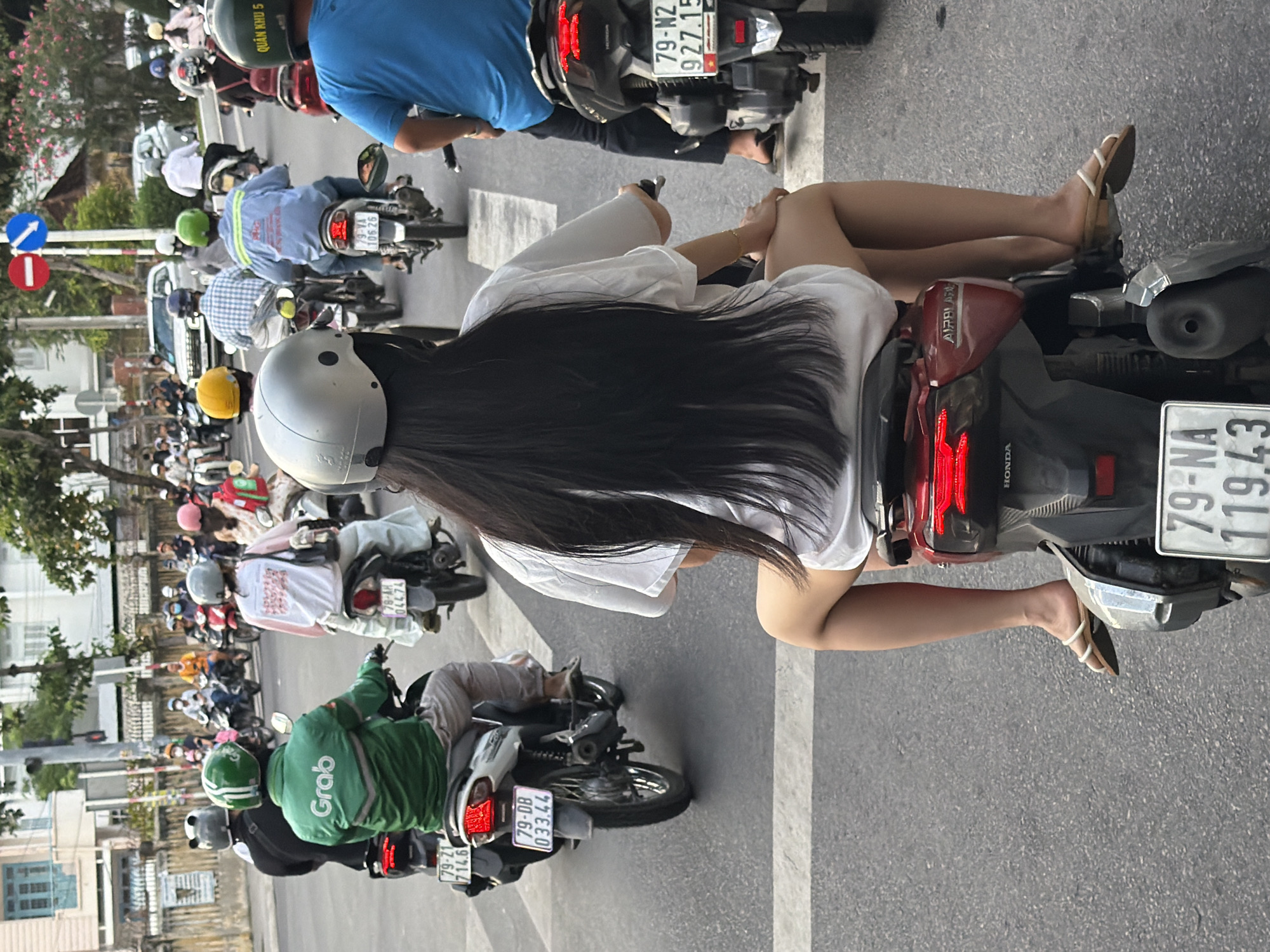 Morning scooter traffic flows through coastal Nha Trang streets