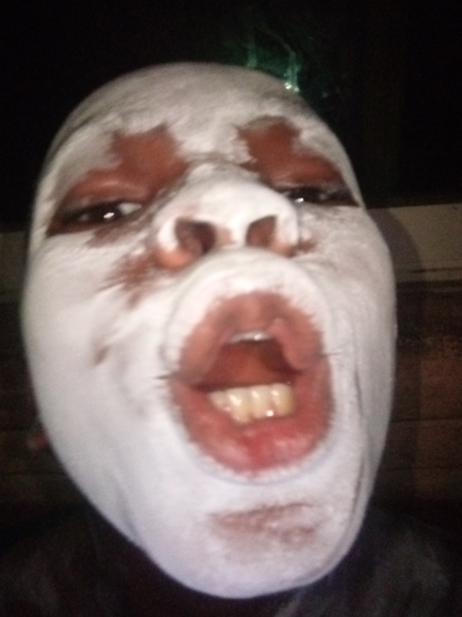 Person photographed with white face makeup in Onitsha