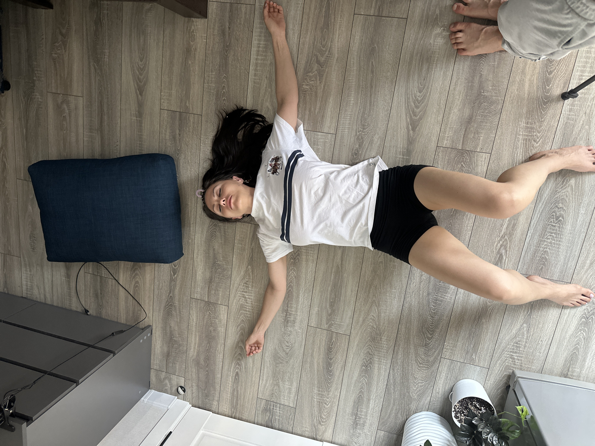 Woman resting on wooden floor in Sinyavino, Russia