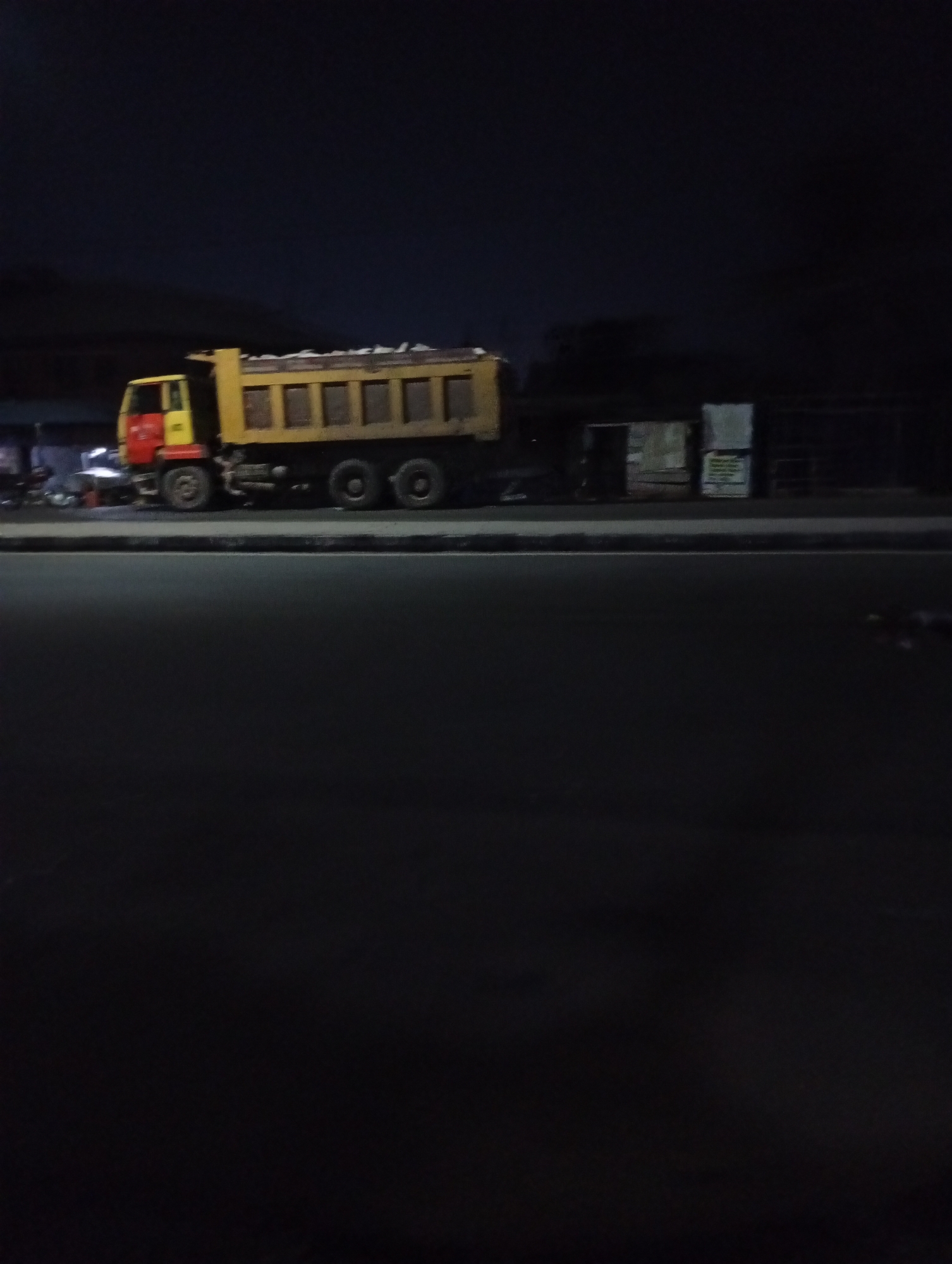 Loaded dump truck spotted parked on urban road overnight
