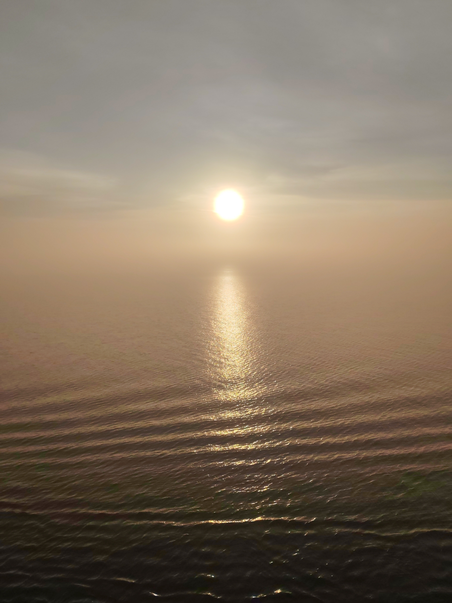 Sunrise observed over Russian waters creates shimmering reflection path