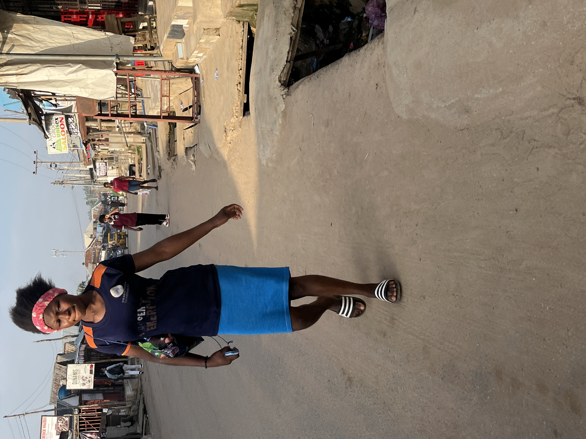 Morning foot and motorcycle traffic on Abuja neighborhood streets