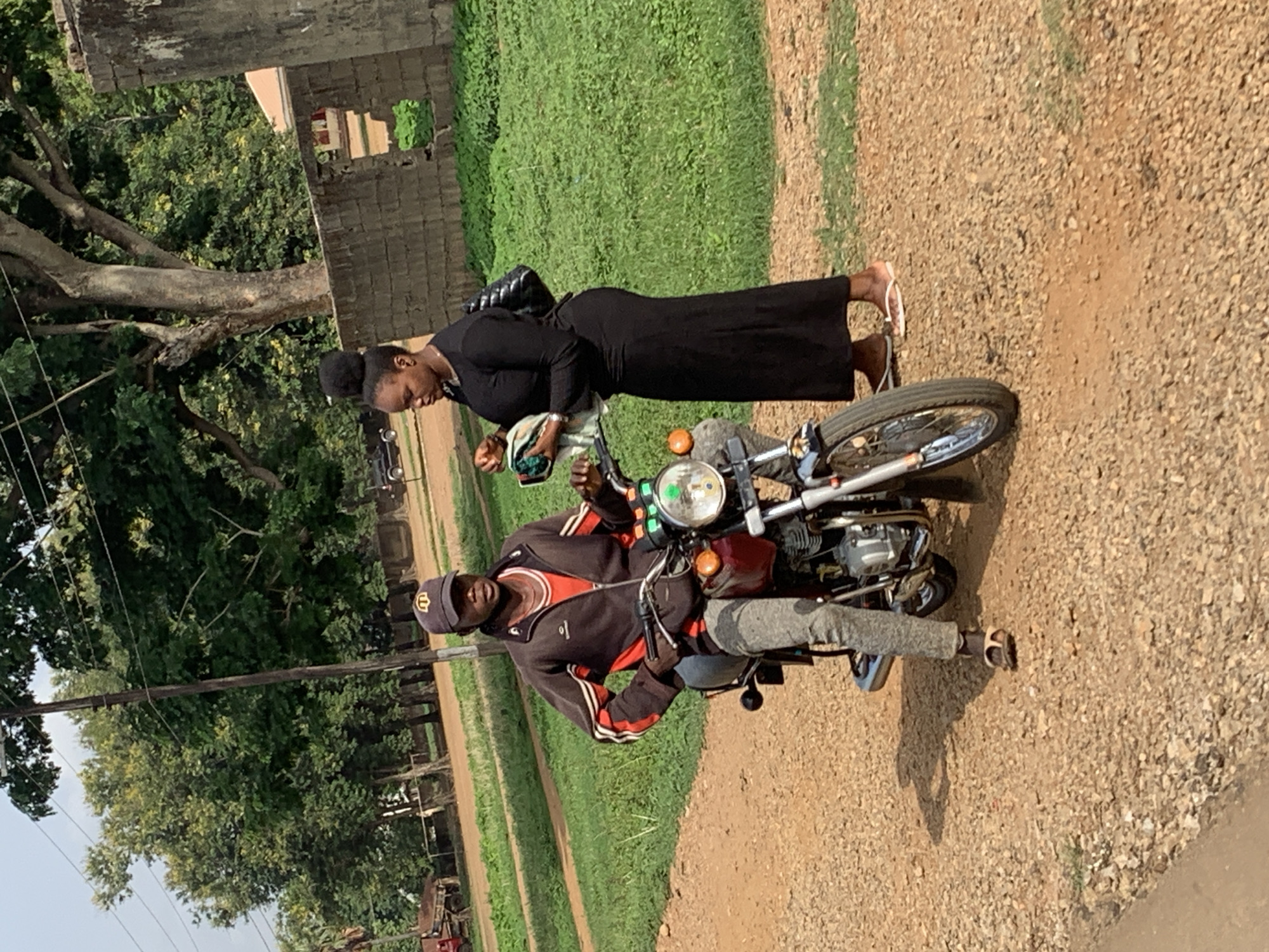 Morning gathering observed in Agban, Nigeria involving motorcycle and pedestrians