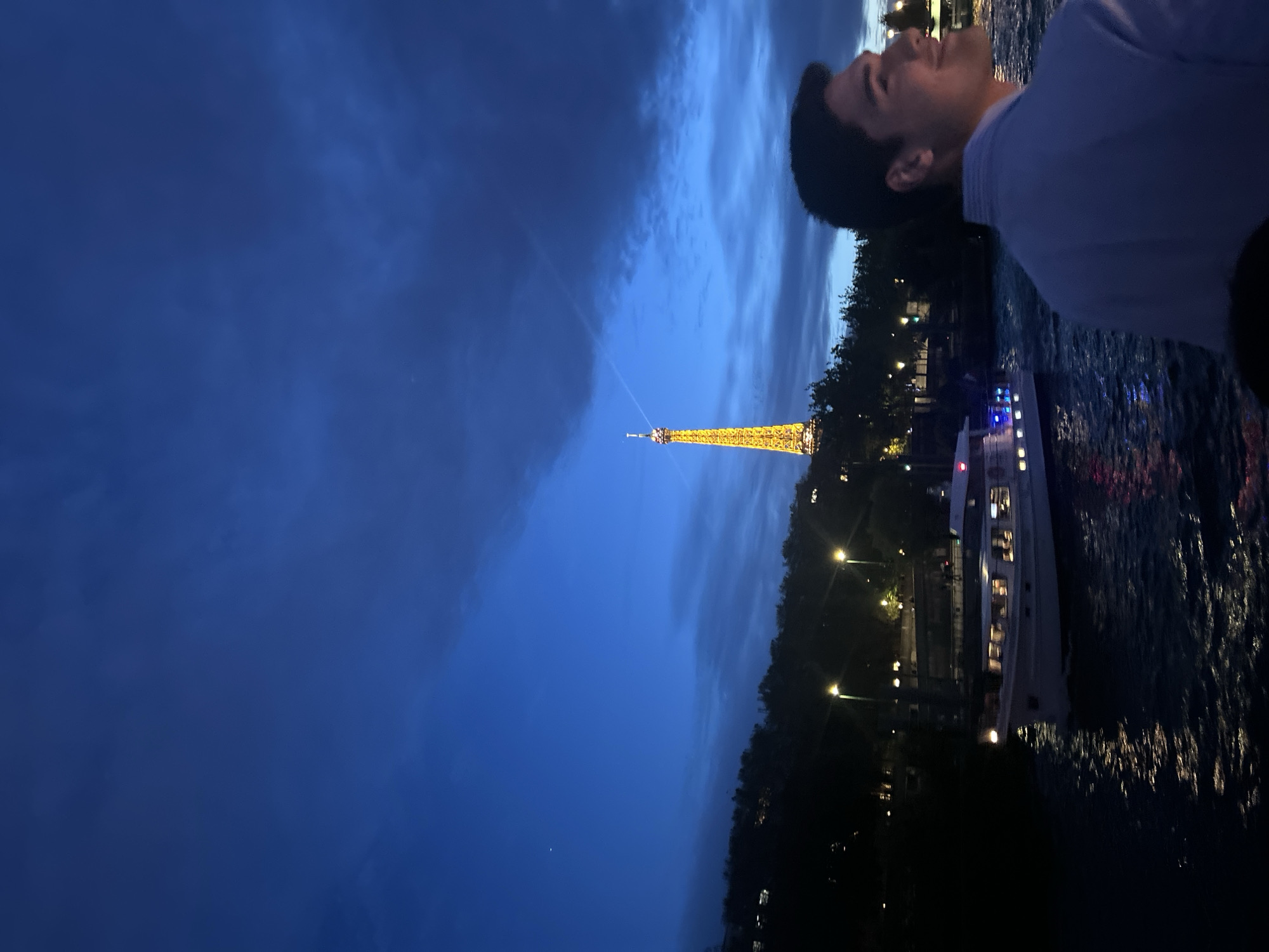 Man gazes at Eiffel Tower during Paris evening