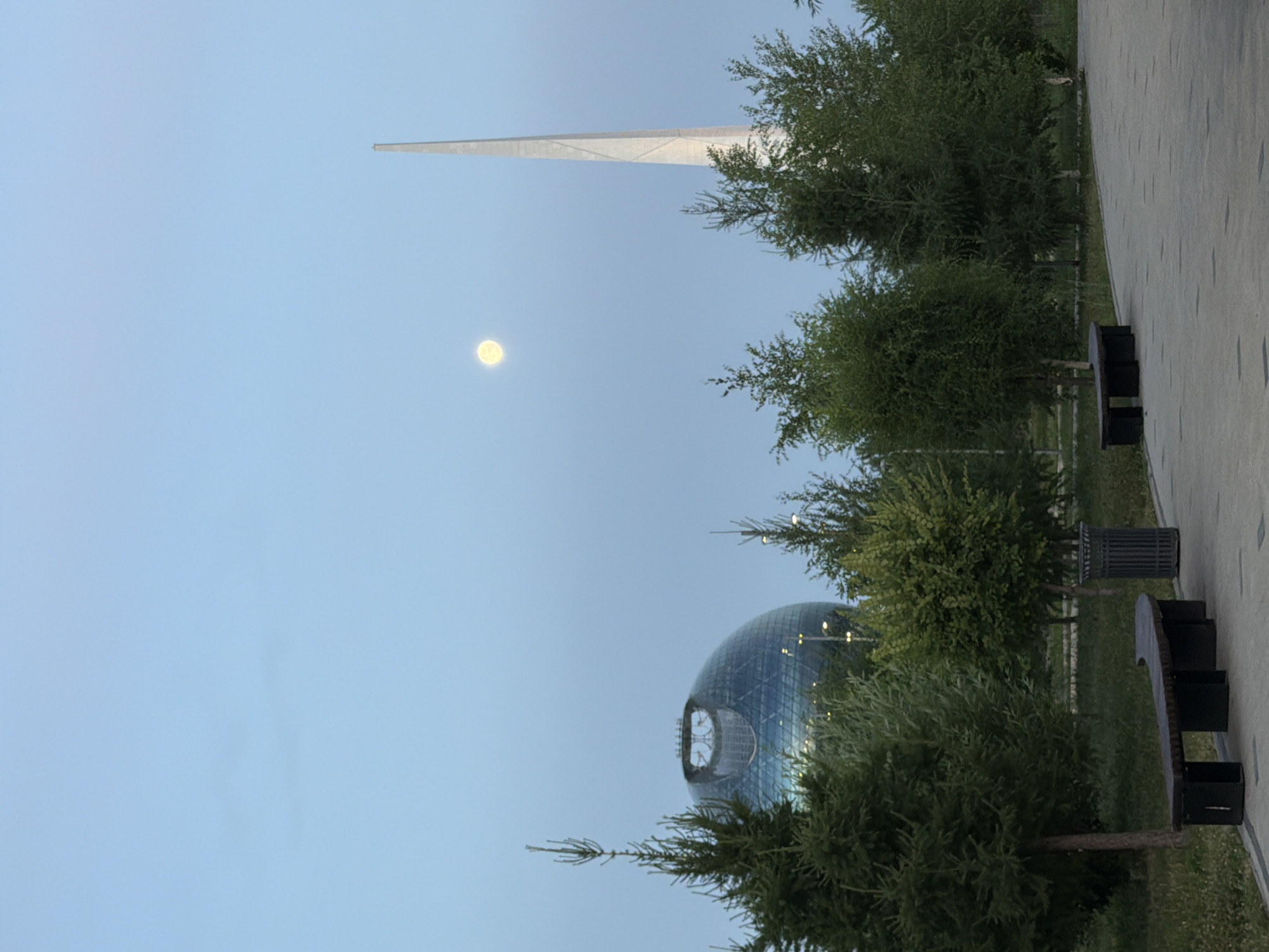 Seagulls and skyline along Astana's waterfront at dusk