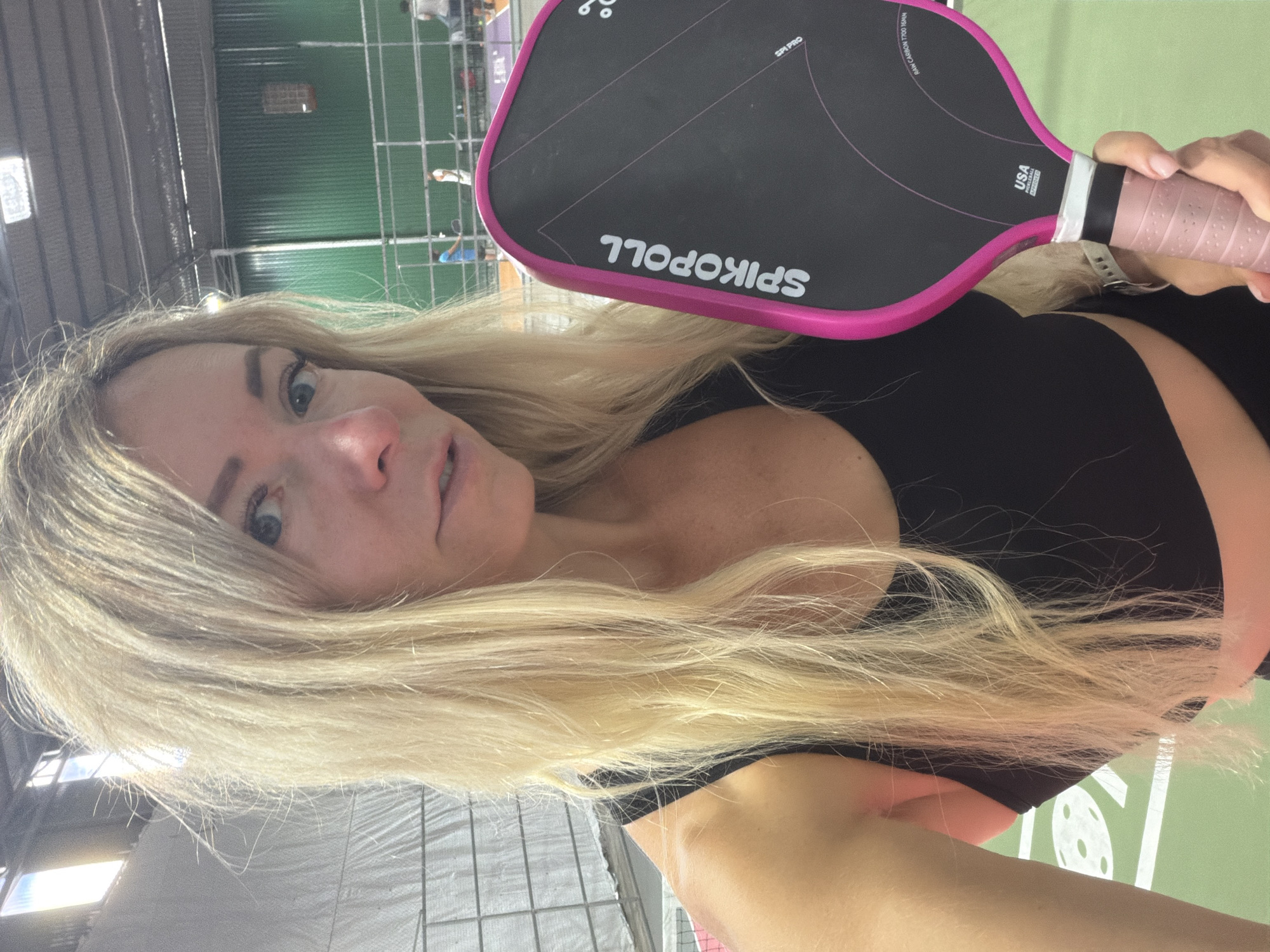 Woman poses with pickleball paddle at Da Lat sports facility