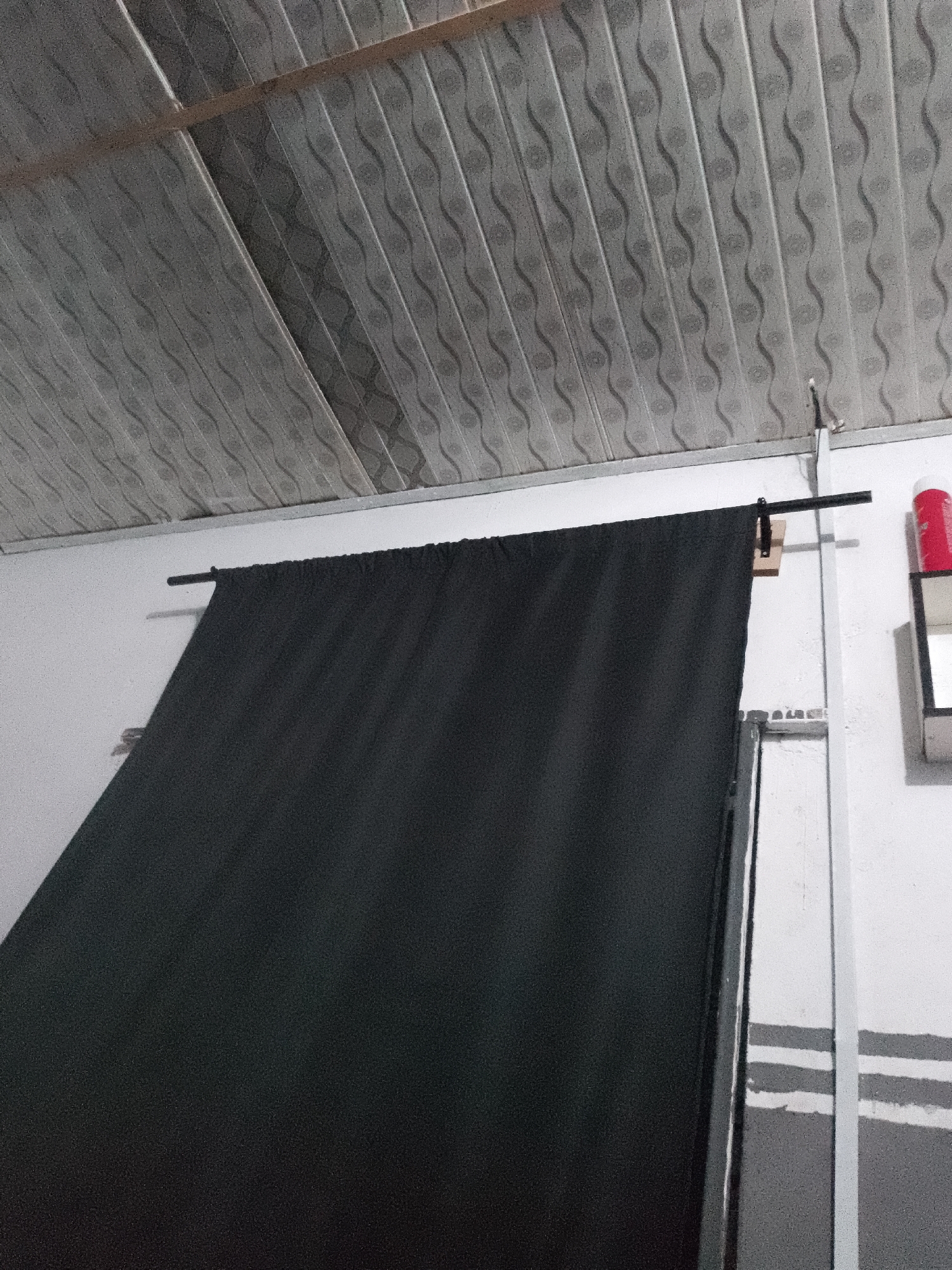 Indoor studio space with fan, curtain backdrop documented
