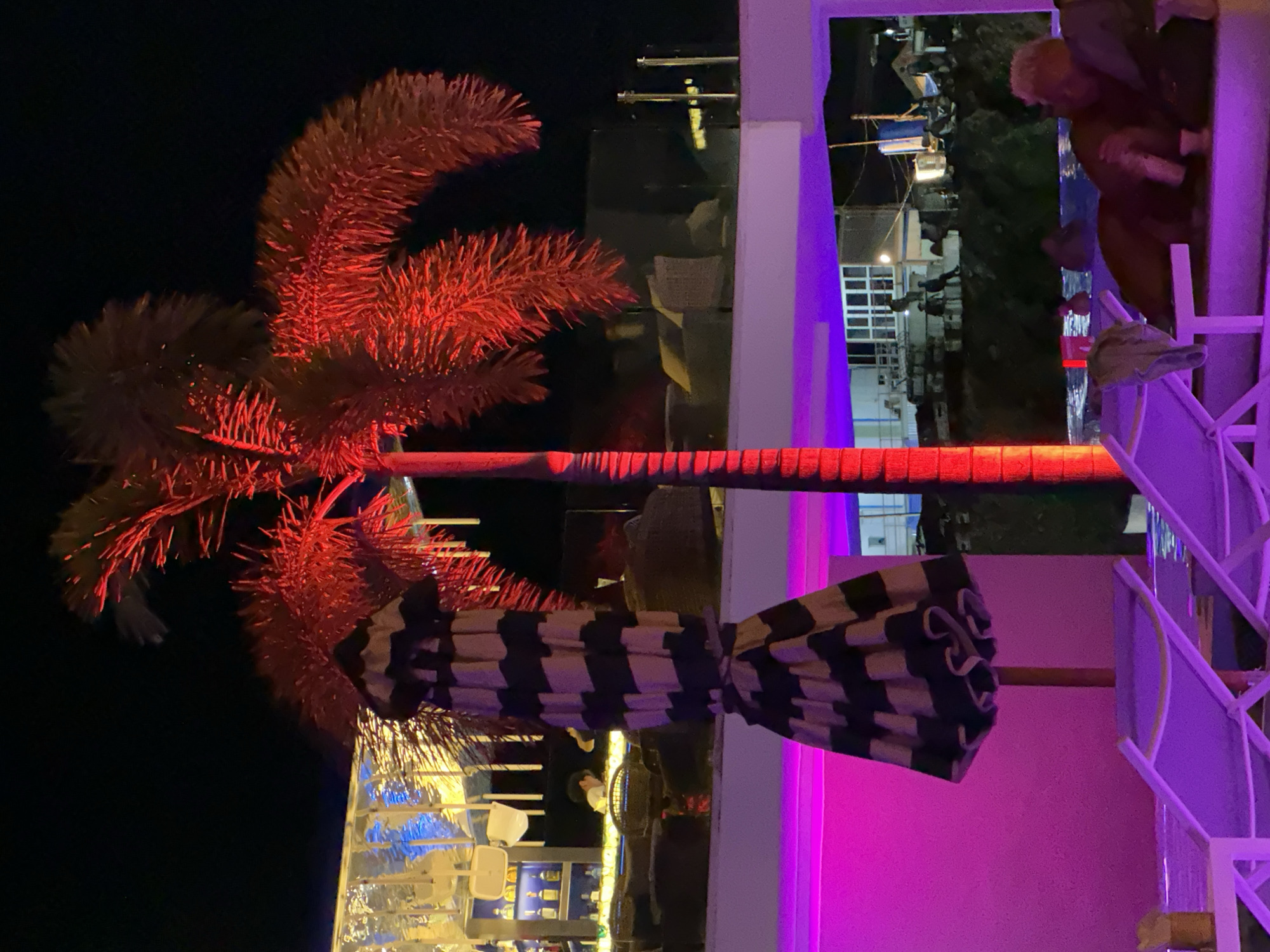 Purple-lit infinity pool and nightlife at a Karon resort