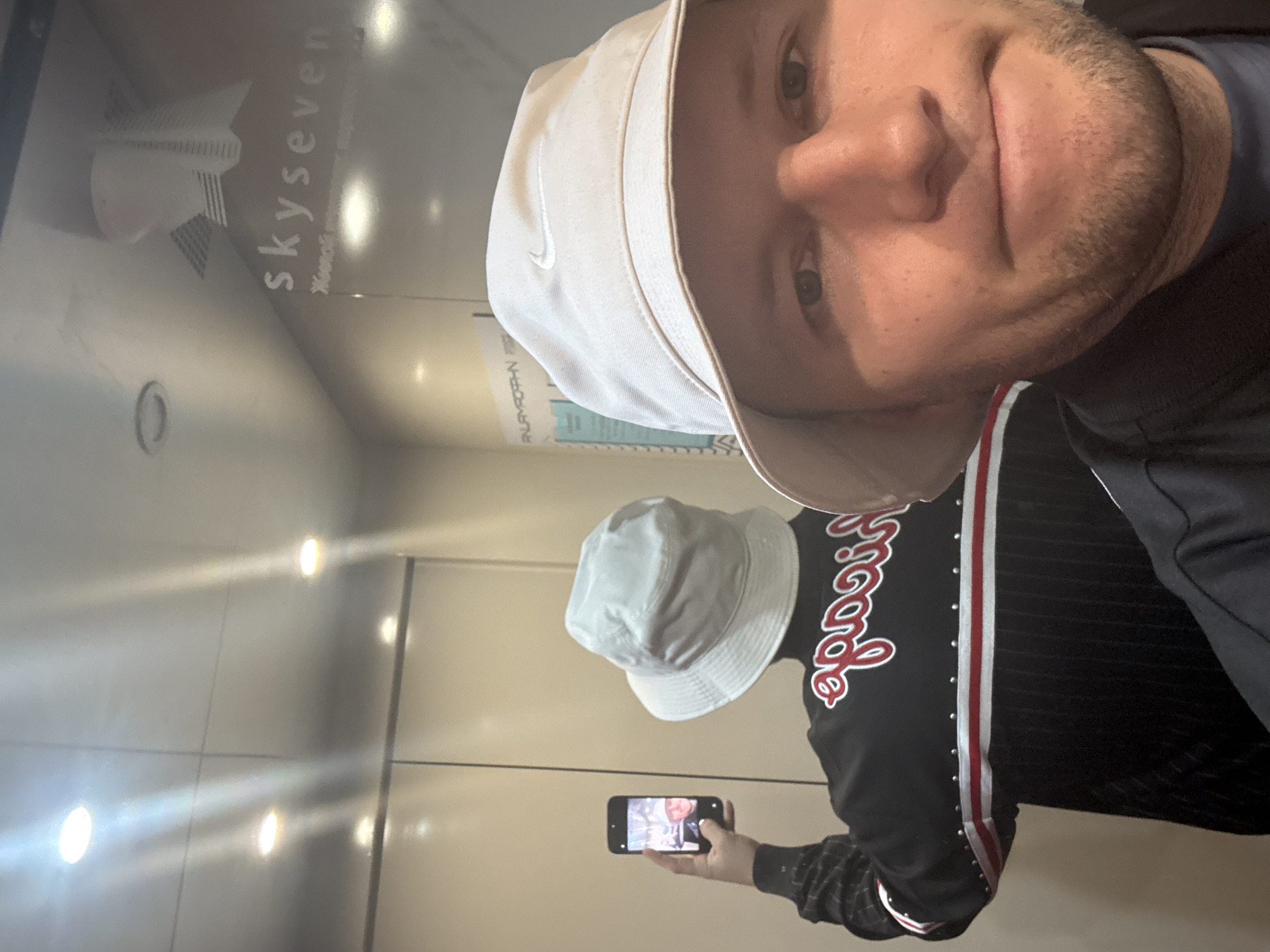 Man takes elevator selfie in Krasnoyarsk wearing Nike hat