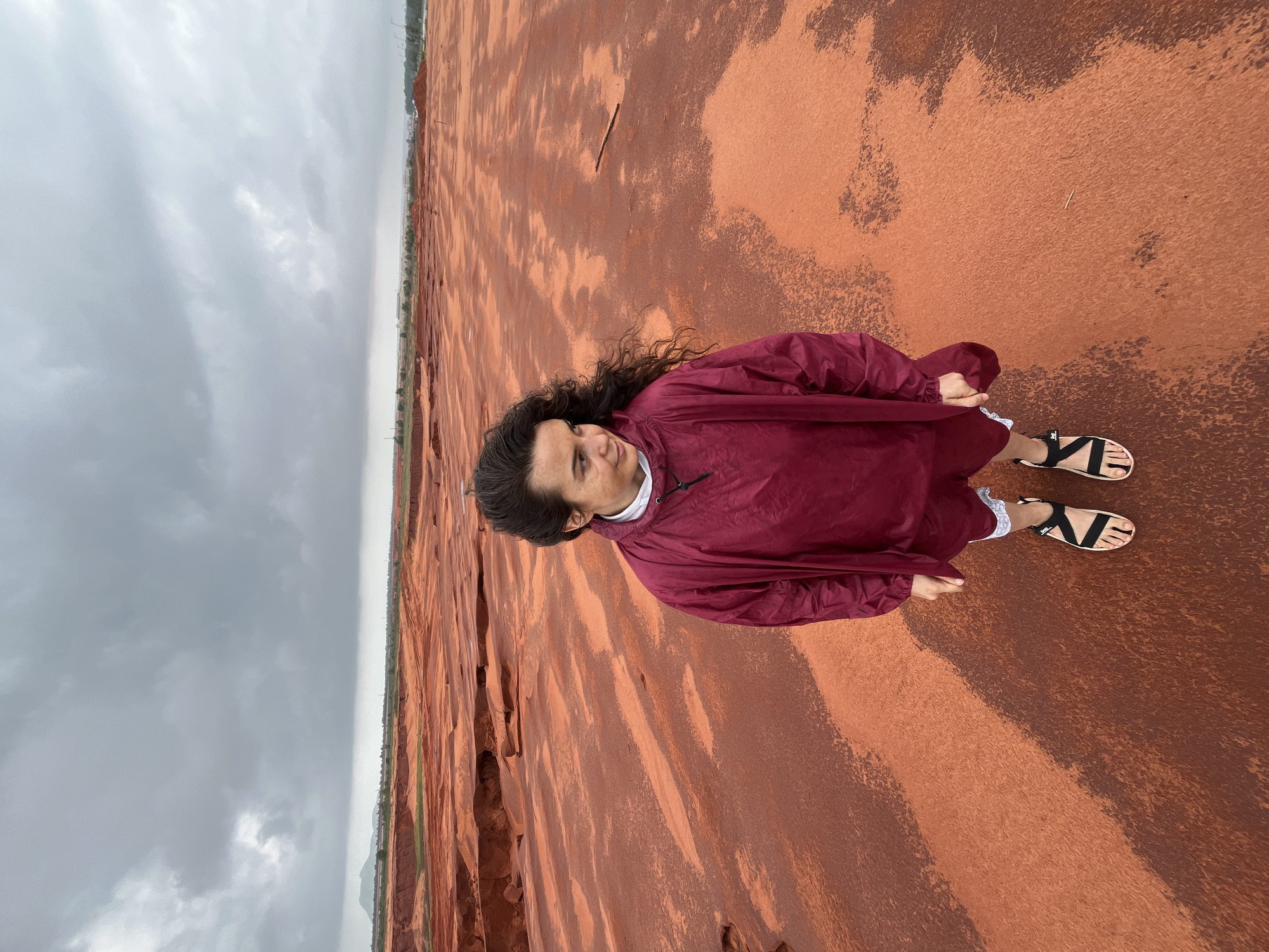 Posing across Mui Ne's red sand dunes on a cloudy day