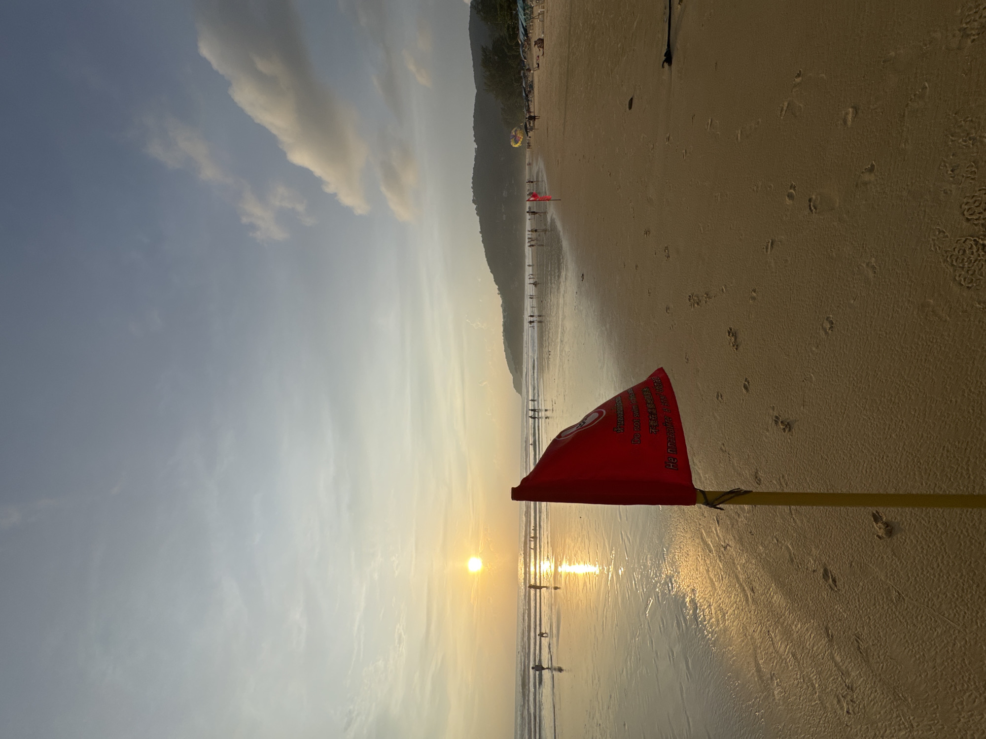 Karon Beach: red swim warning, parasailing, and golden hour