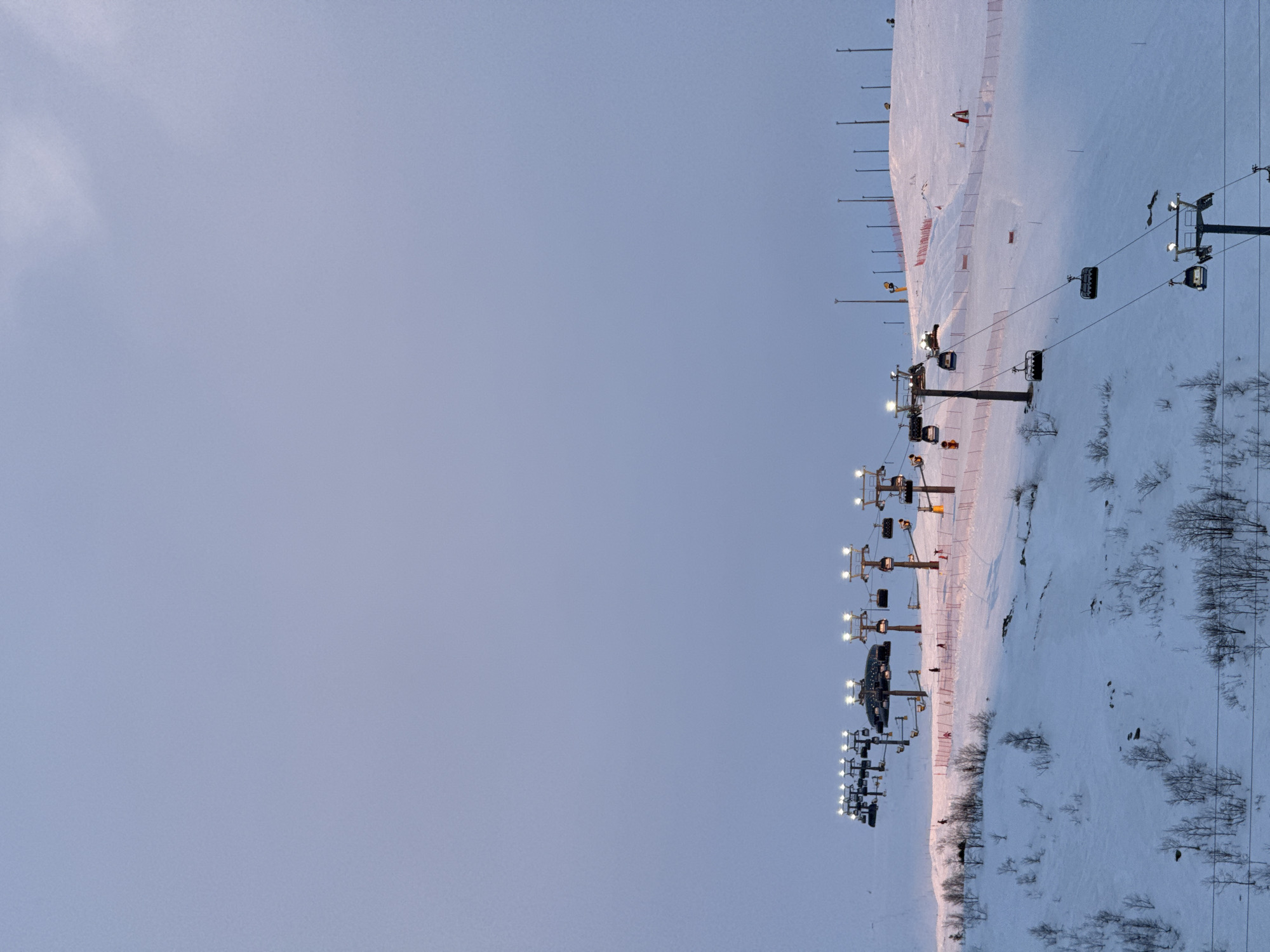 Illuminated ski lift operates at dusk in Kirovsk resort