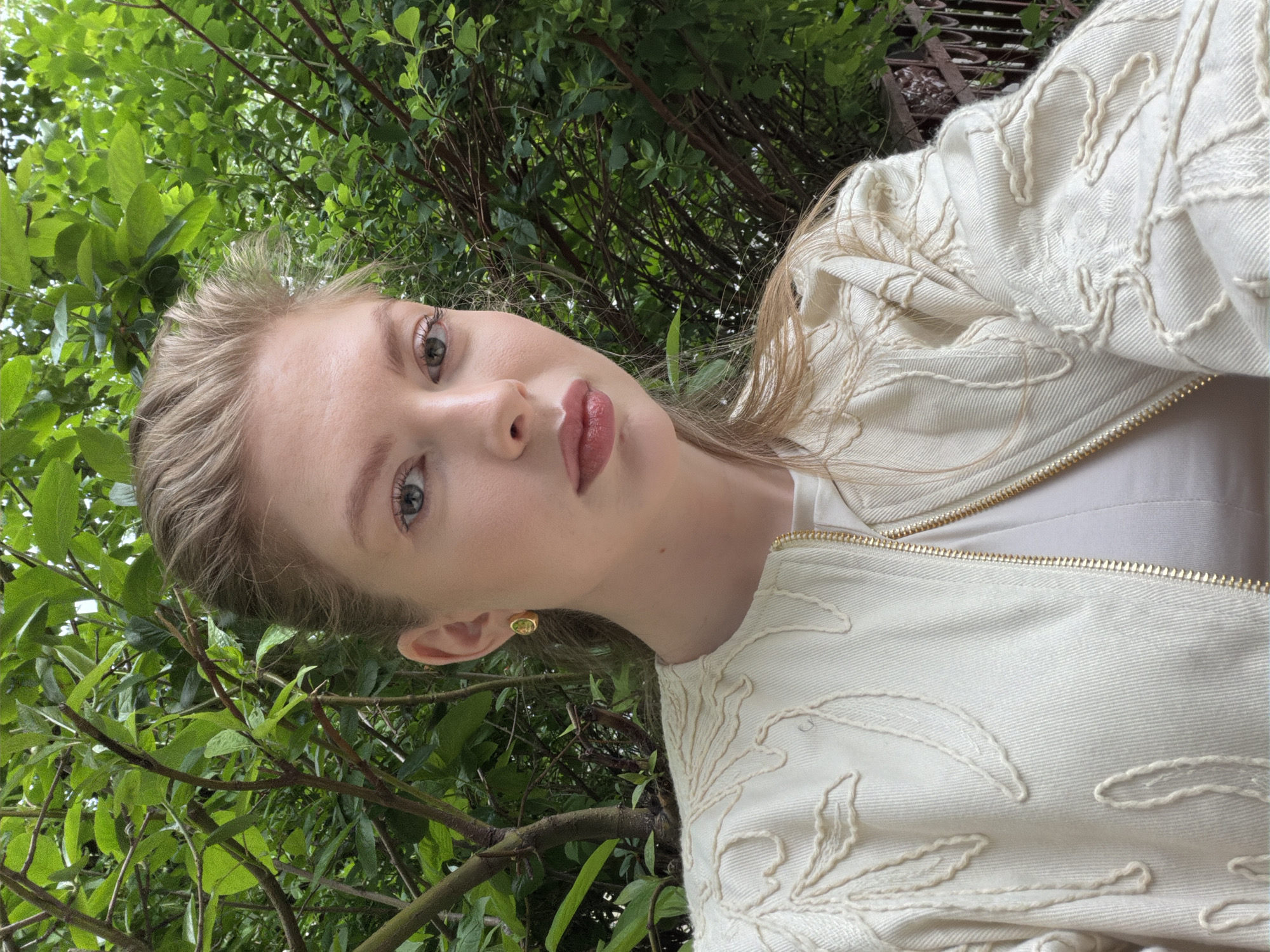 Woman poses for selfie among greenery in Moscow