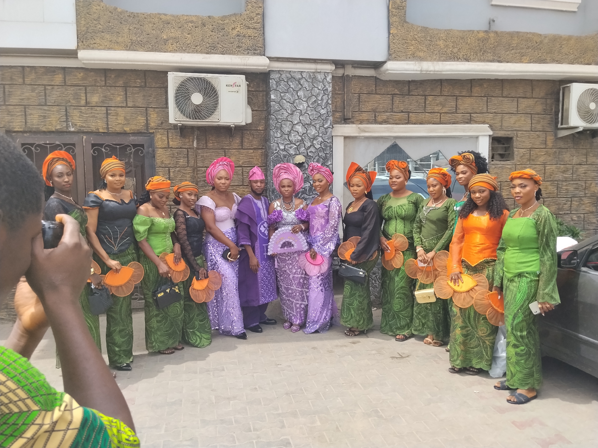 Groups gather for photos outside building in Nigeria