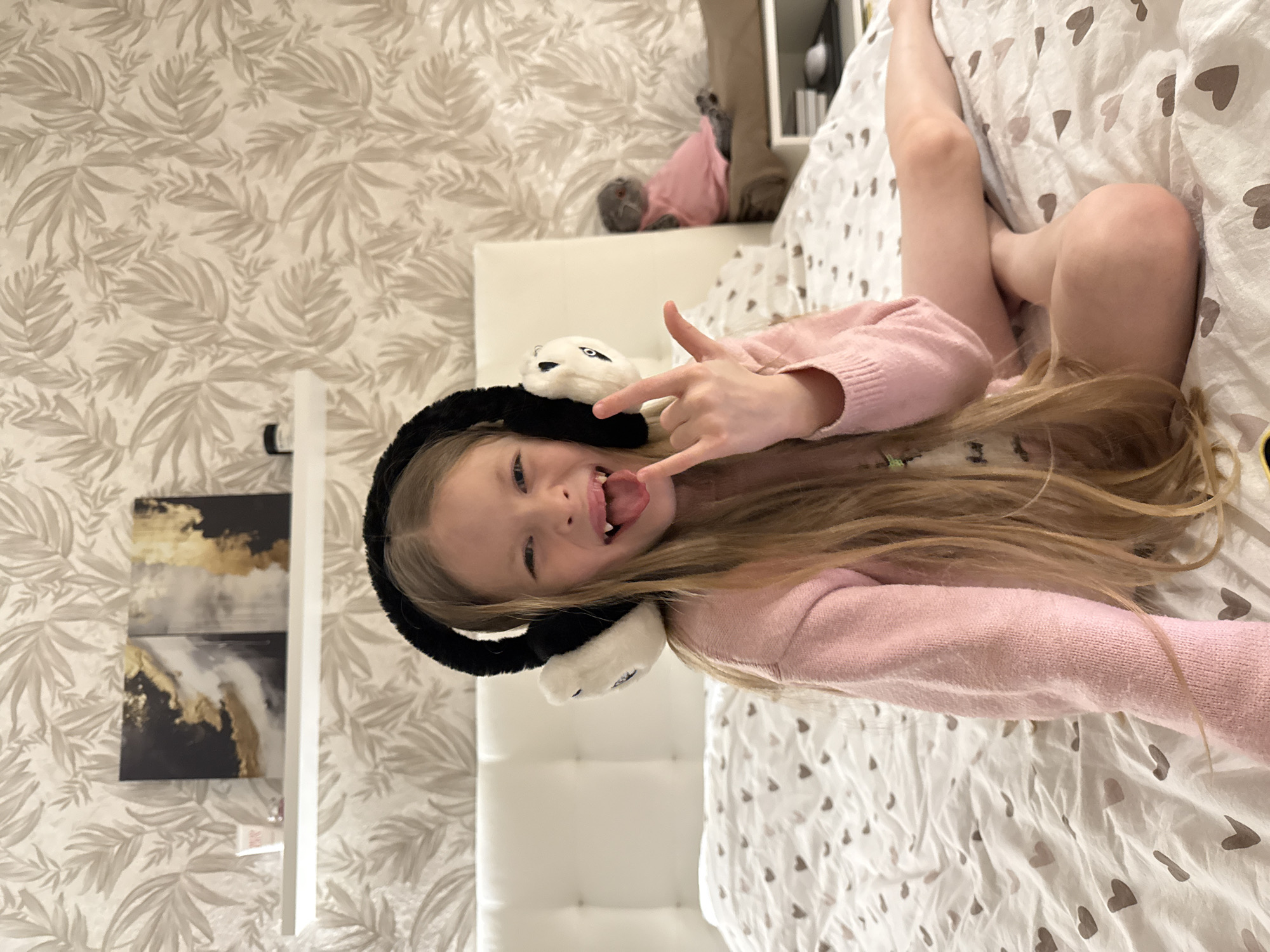 Woman takes selfies in Izhevsk bathroom wearing cat headphones