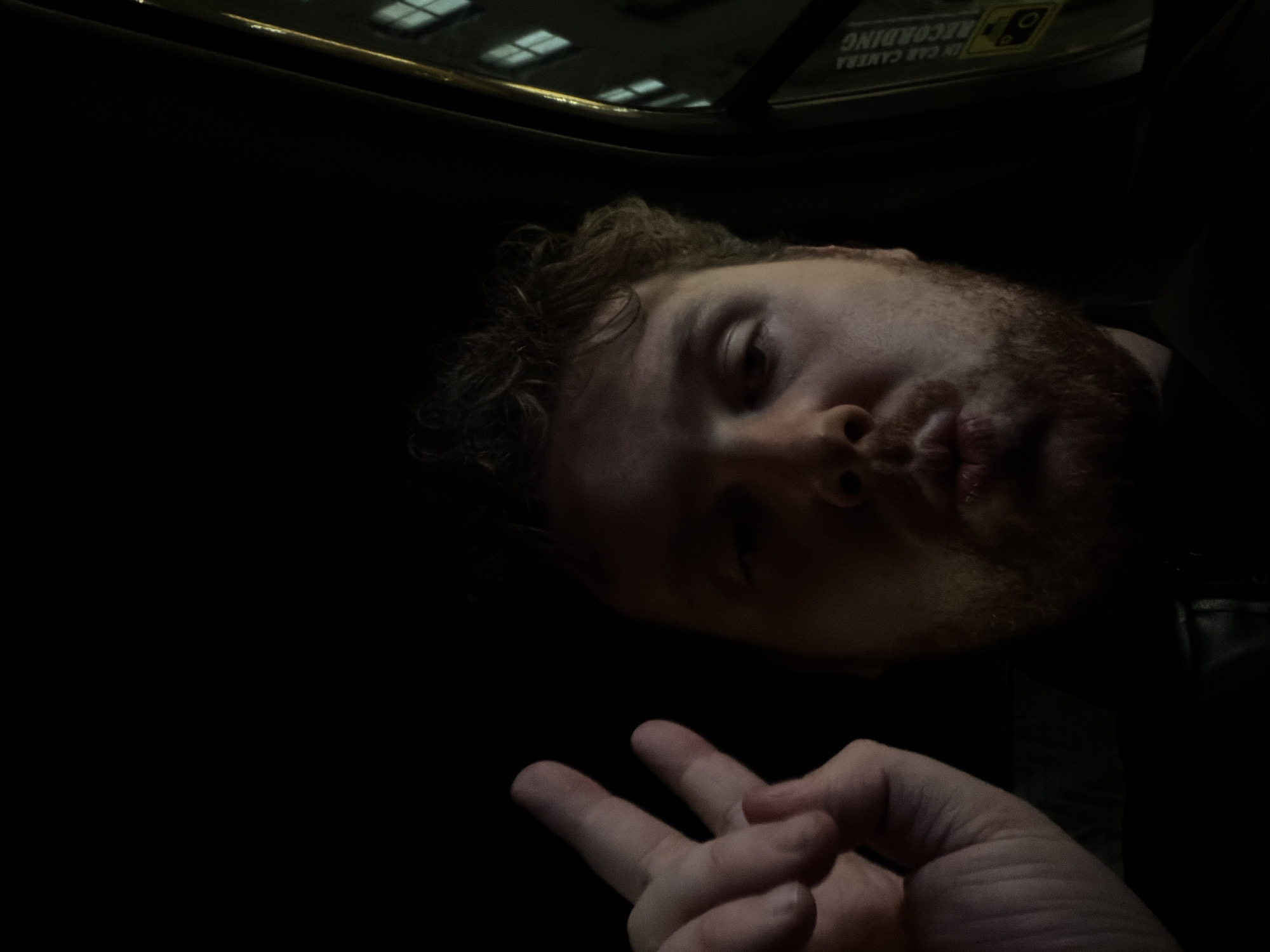 Man makes peace sign in moving NYC vehicle