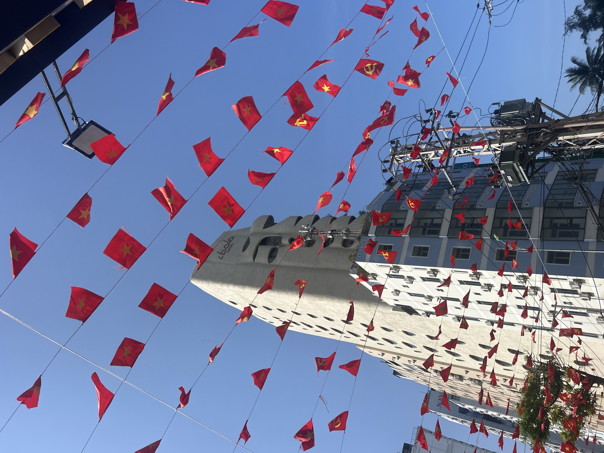 Red flags line street overhead in Bắc Nha Trang