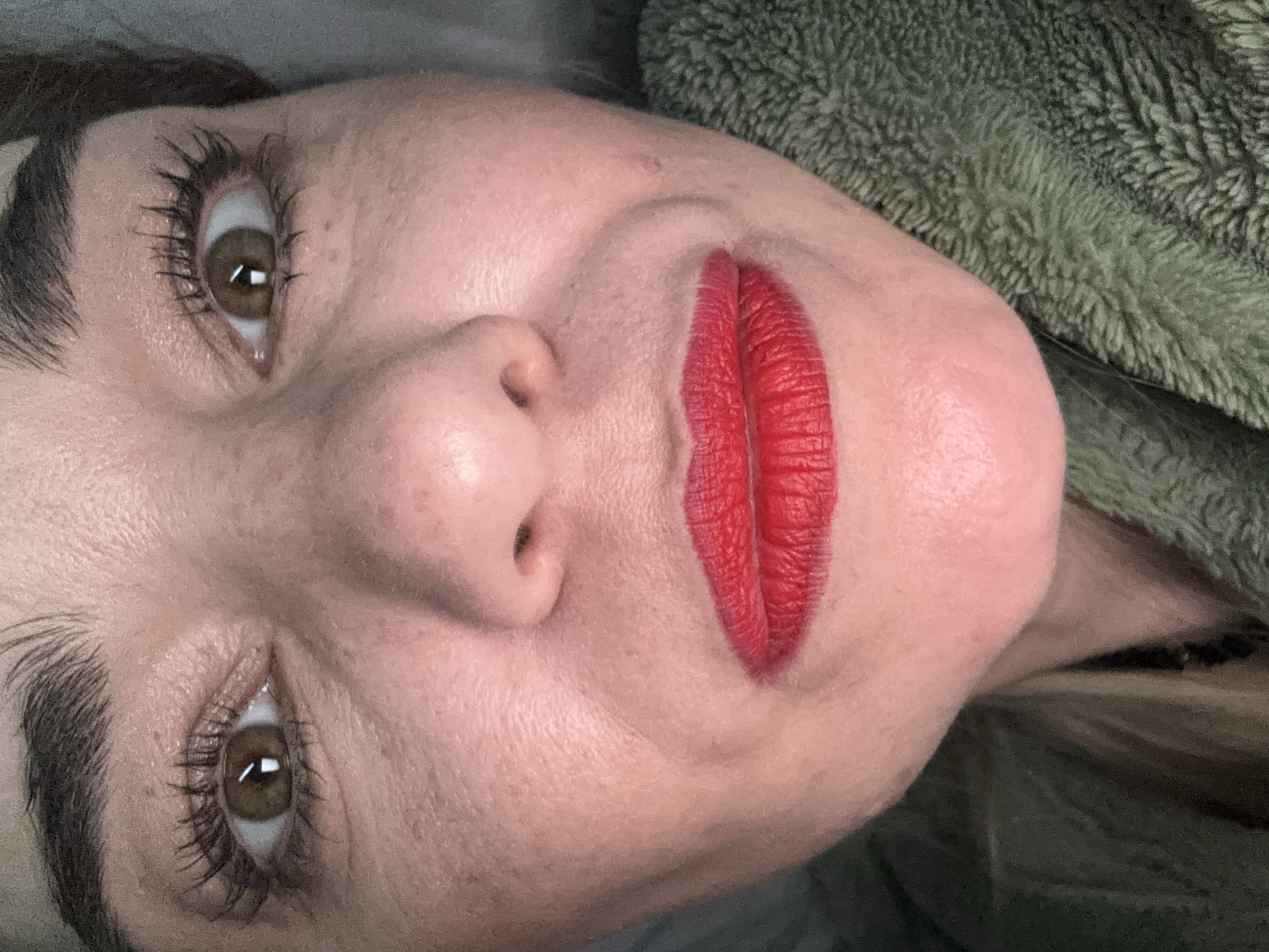 Woman in green robe photographed resting in Murino bedroom