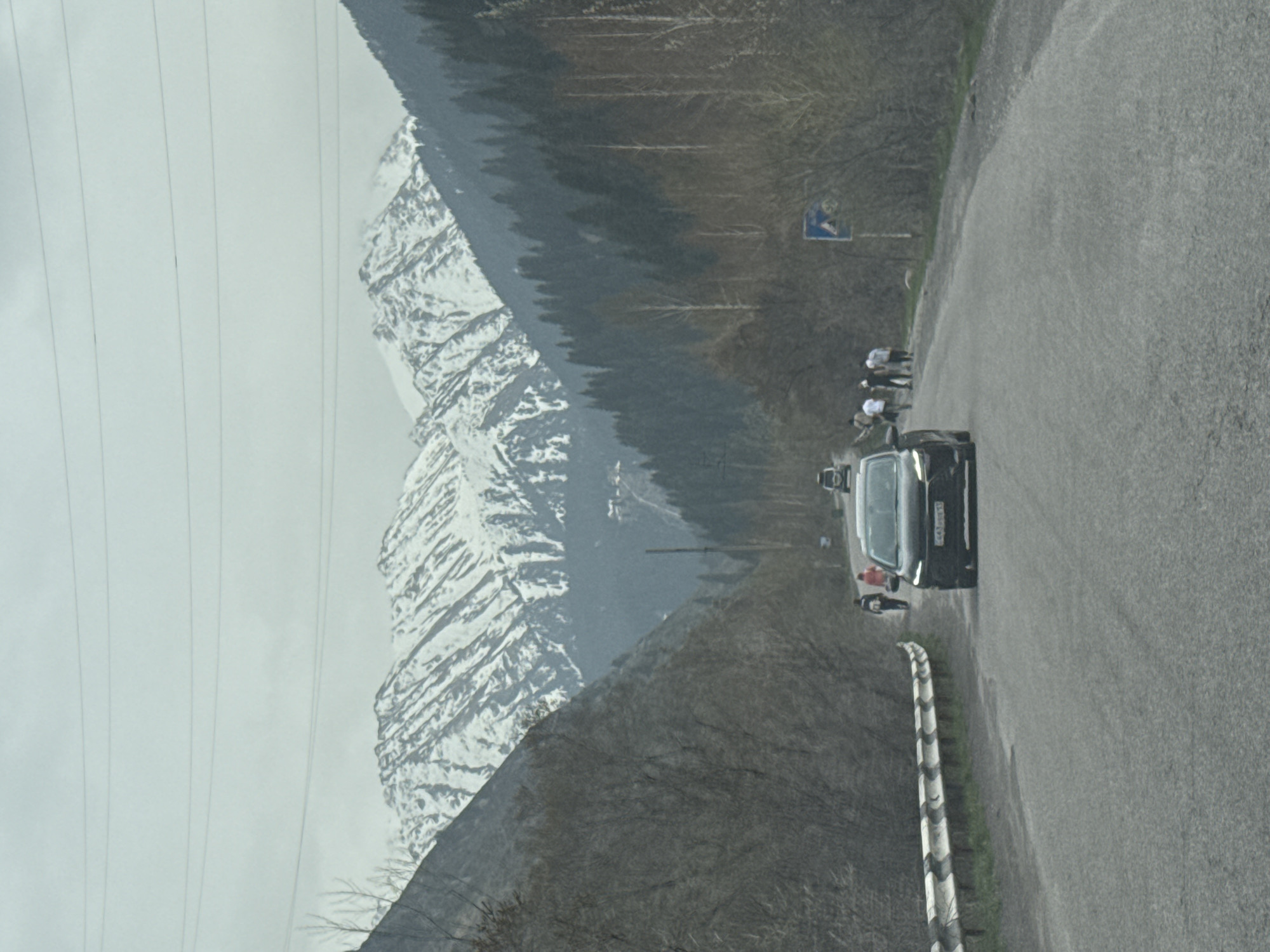 Woman drives through mountain valley near Almaty, Kazakhstan