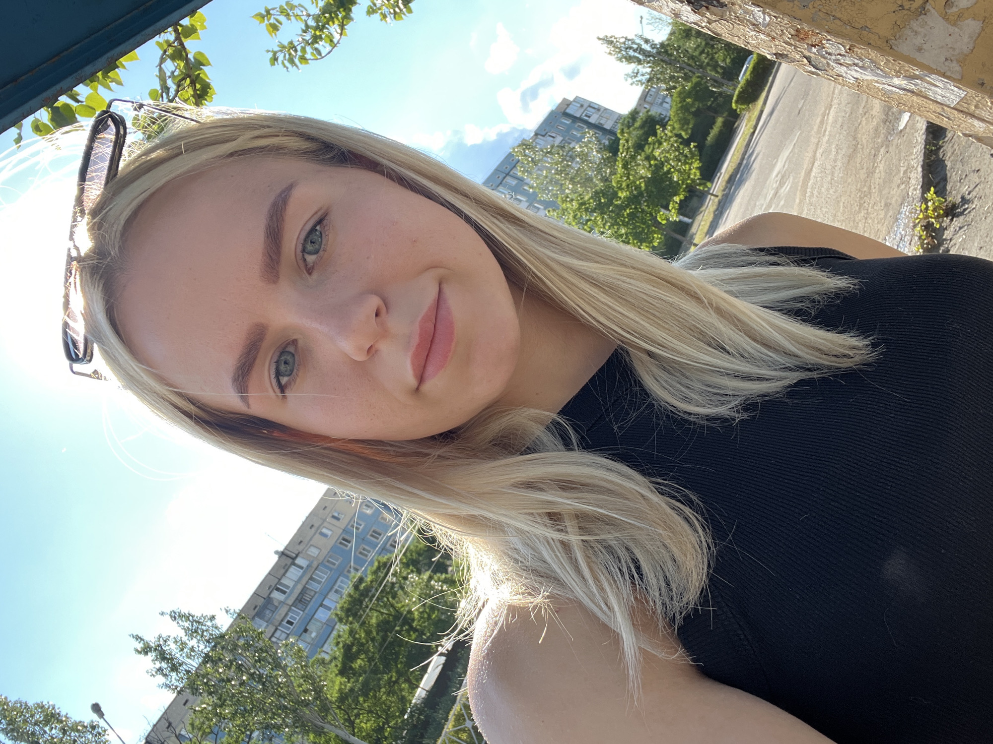 Sunny day selfies on an urban street, peace sign shadow nearby