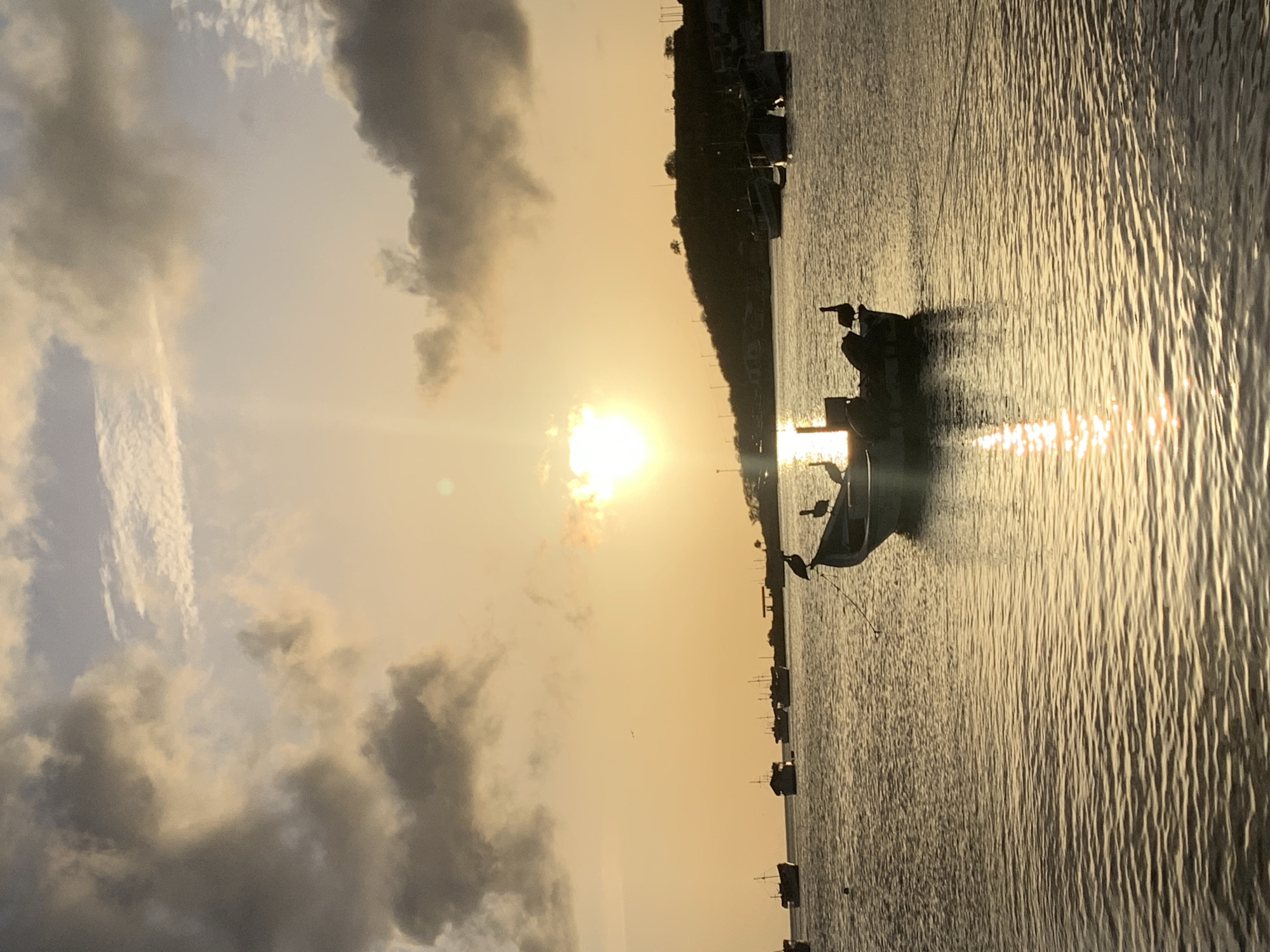 Sunset over Juan Griego's bay, boats and town life