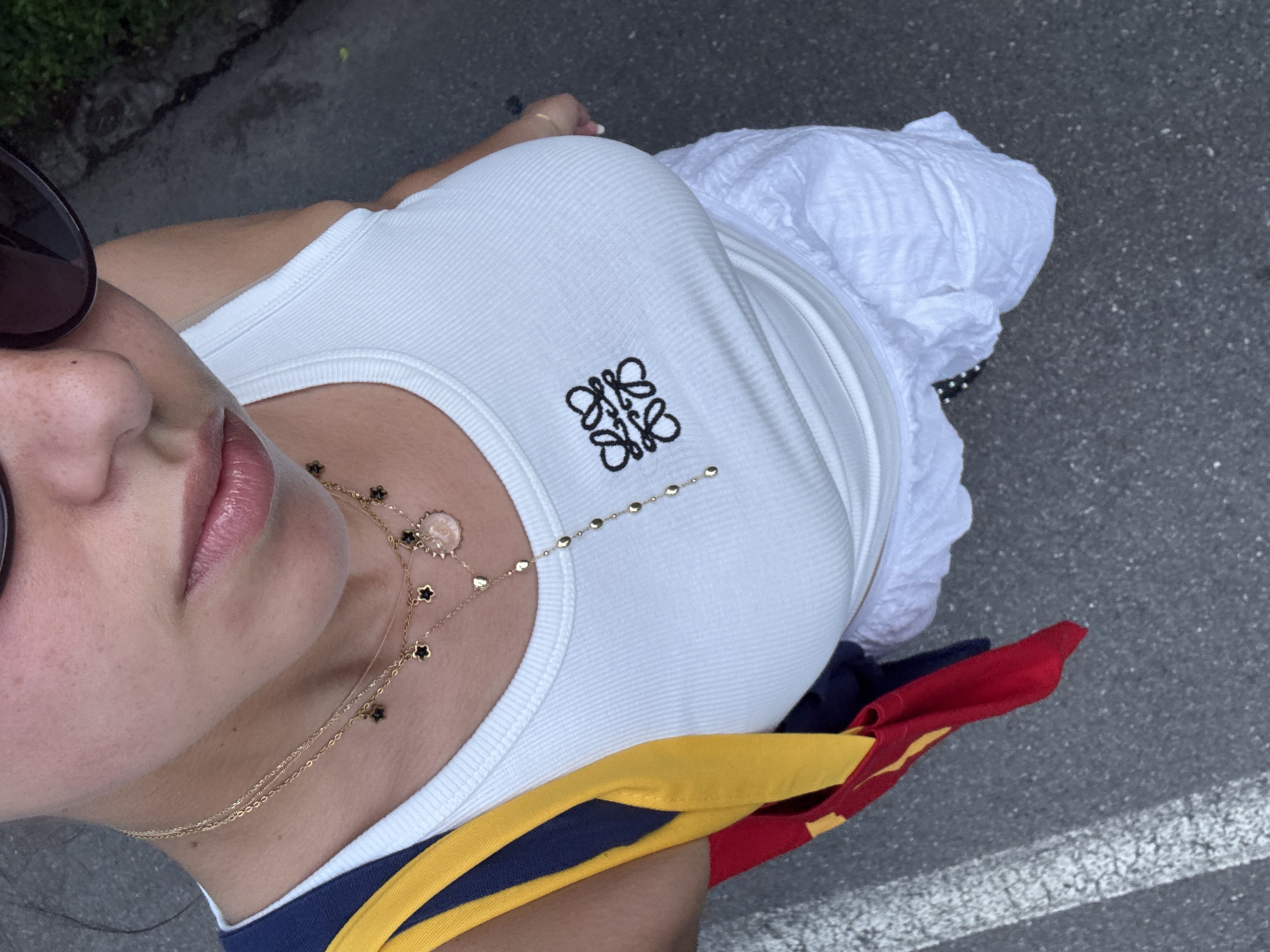 Woman in designer tank top photographed in Milan