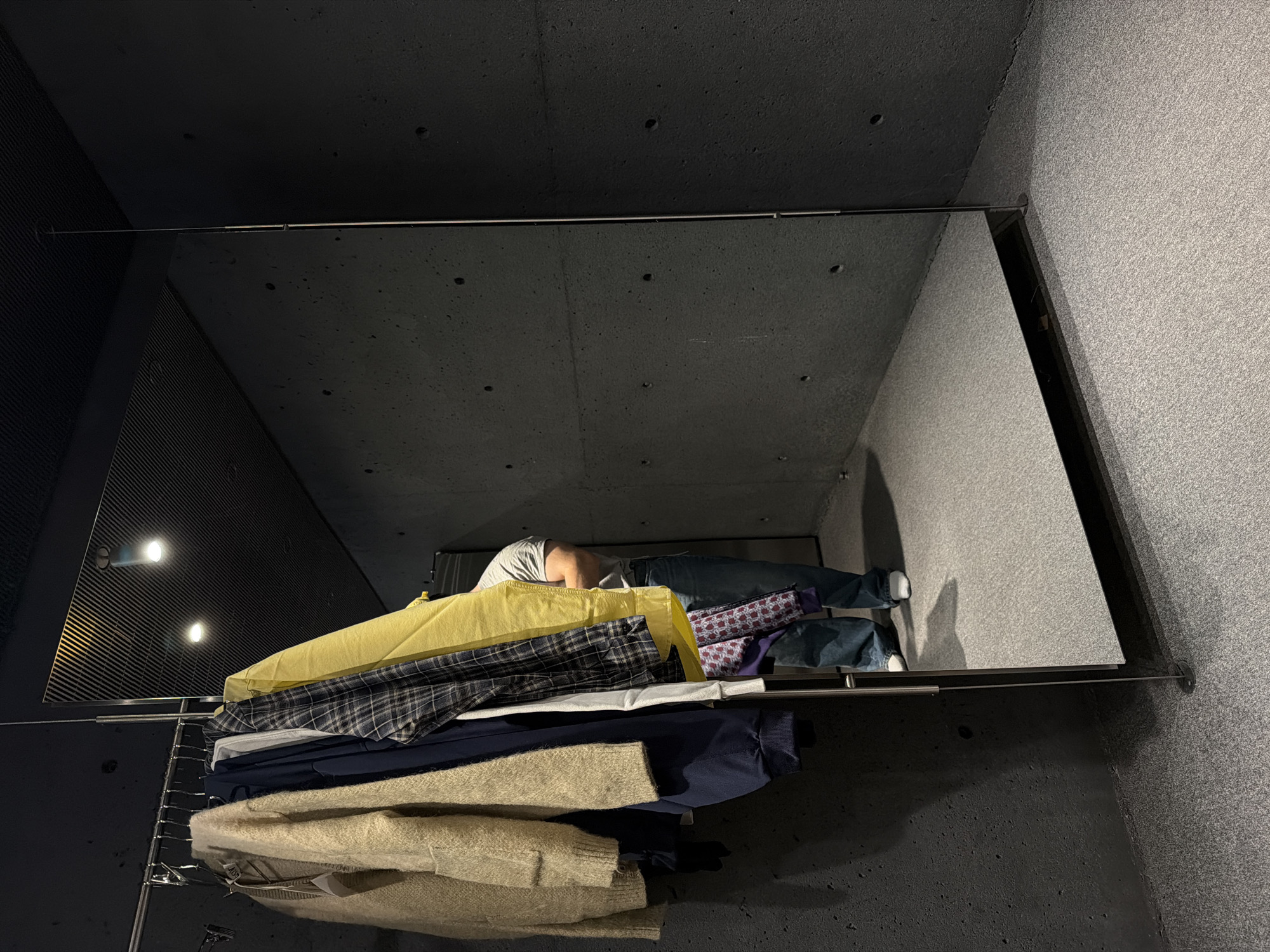 Mirror display with person and clothing rack spotted in Montreal