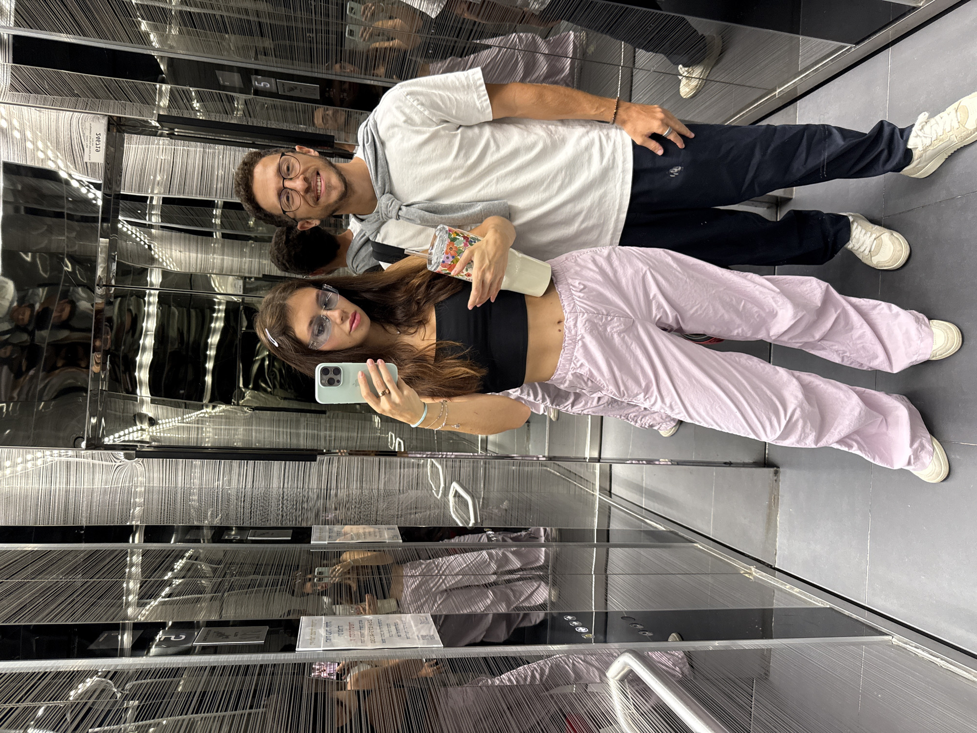 Couple takes selfie in mirrored elevator in Tel Aviv