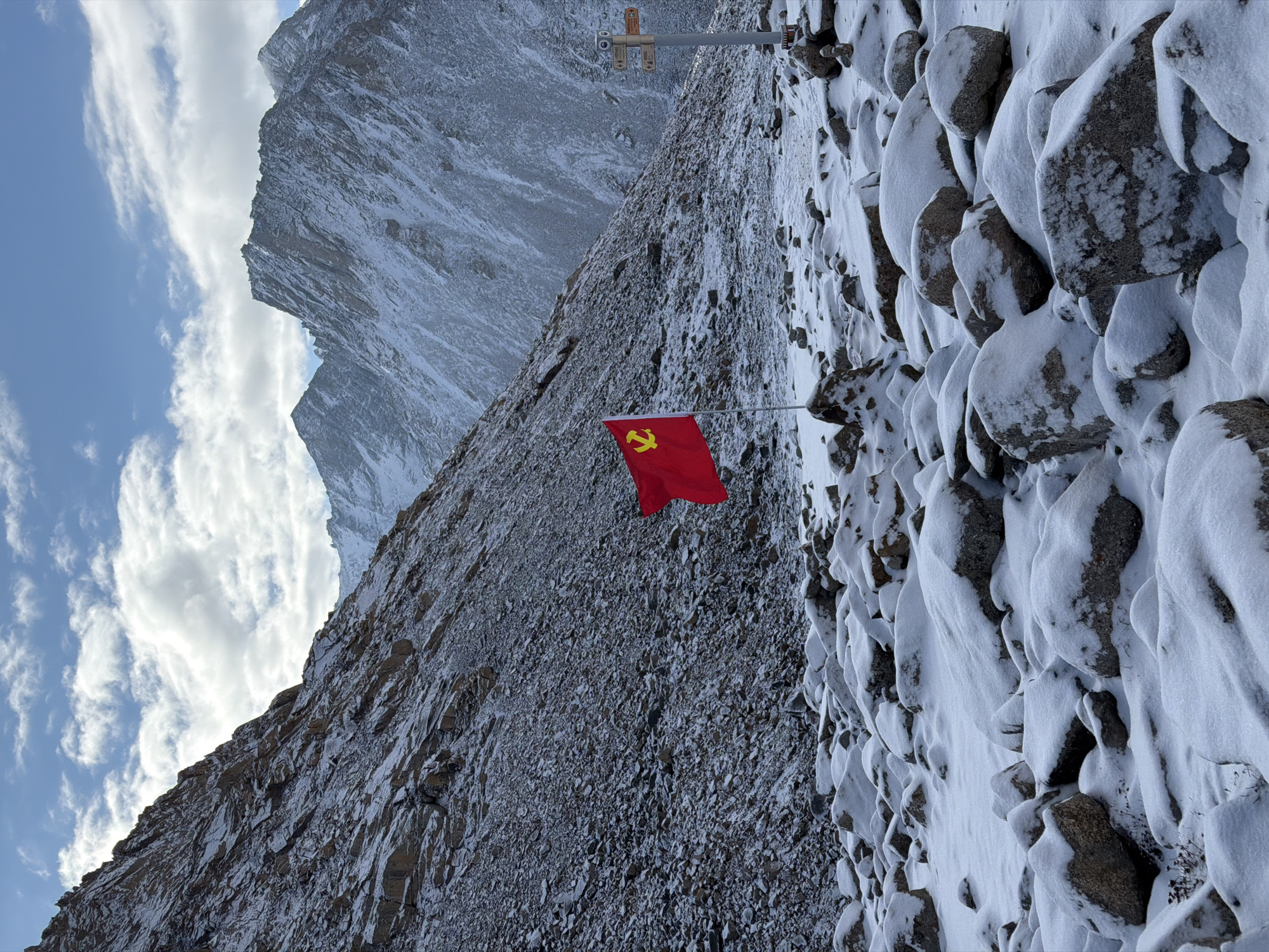 Communist flag planted on snowy Chinese mountain peak
