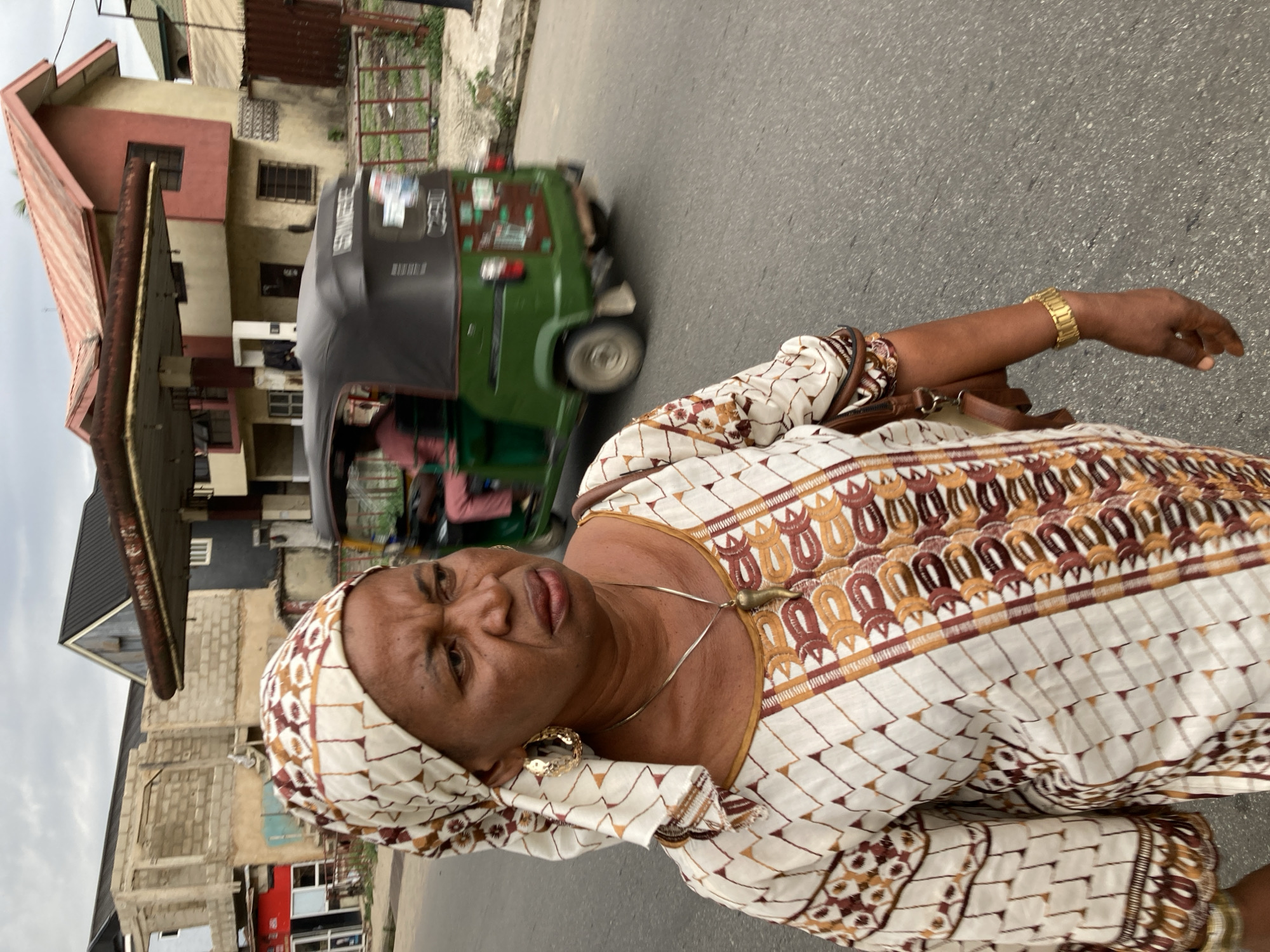 Woman in traditional dress walks street in Umuode, Nigeria
