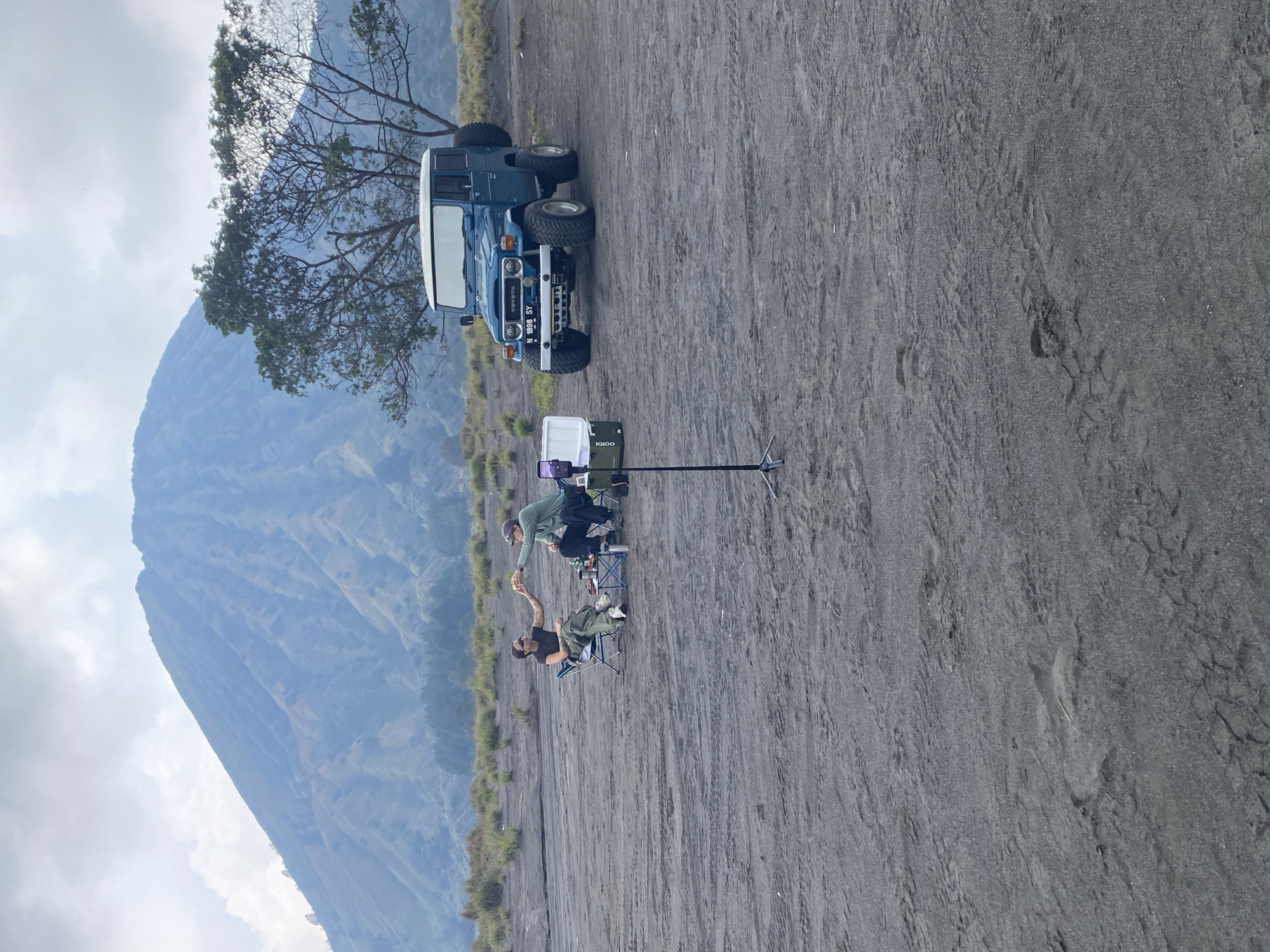 Two people filmed near Toyota on volcanic terrain, Indonesia