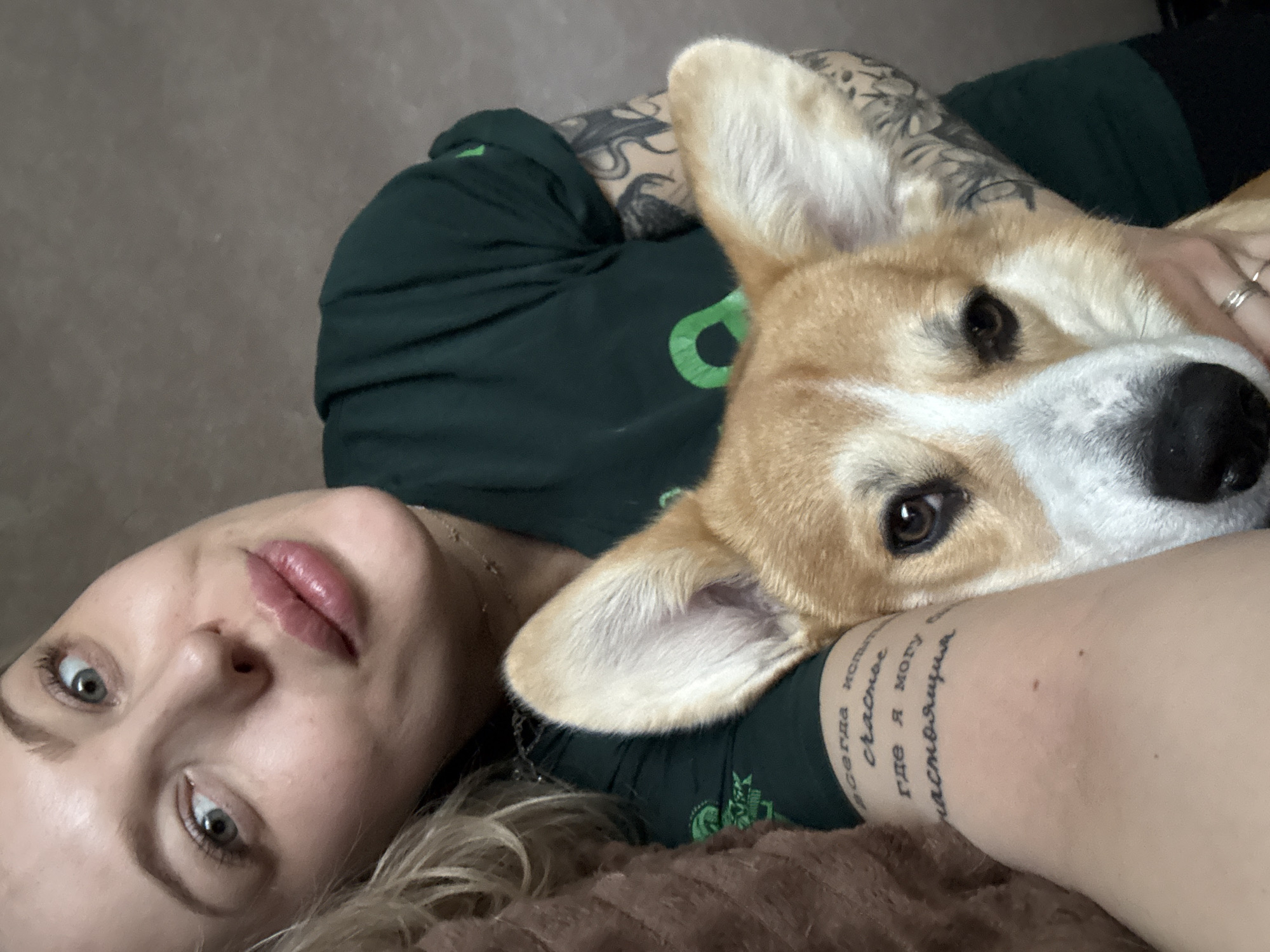 Woman rests with corgi companion in Borzya, Russia