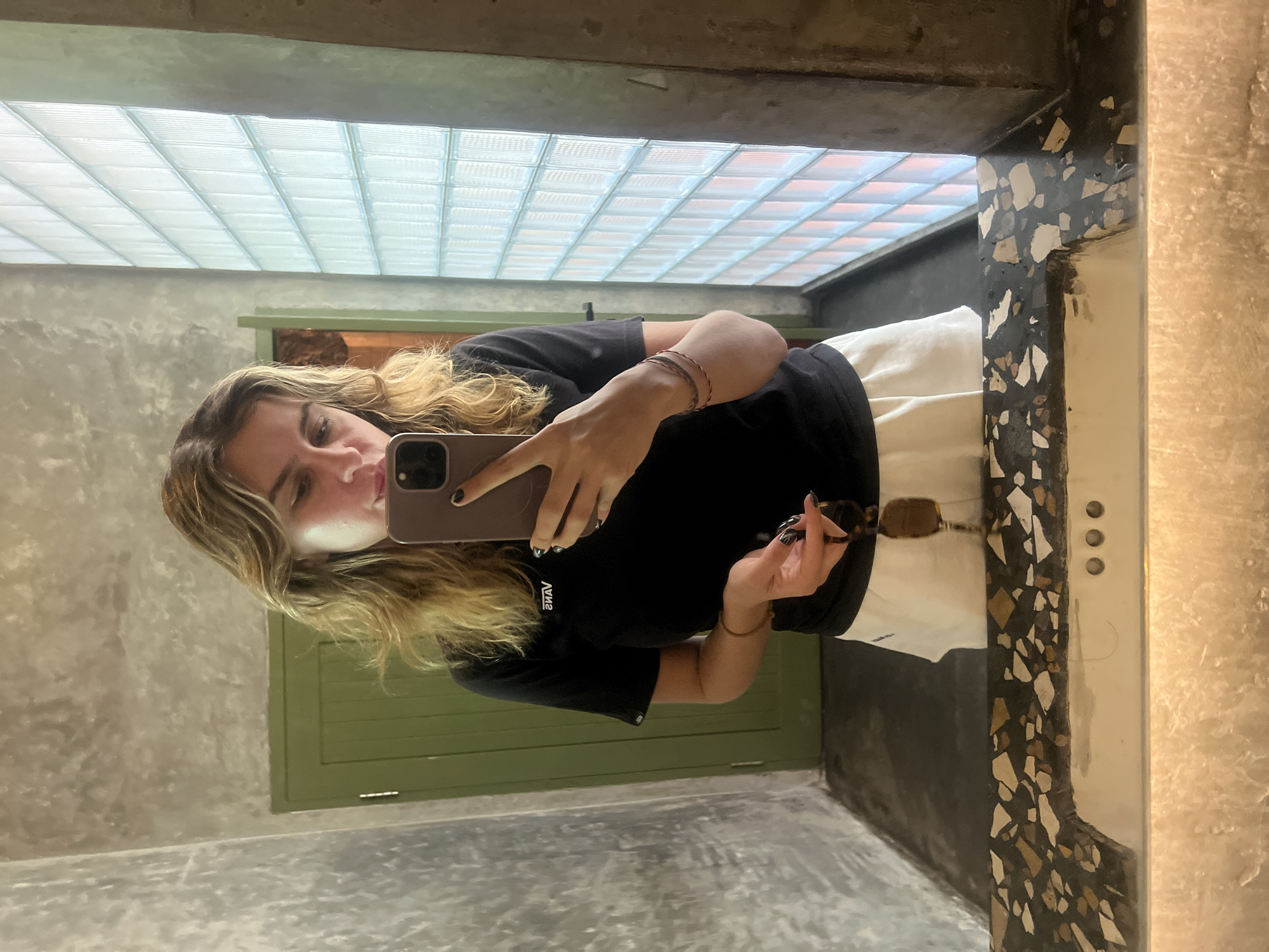 Casual mirror selfie in a concrete bathroom, Kuta Selatan.