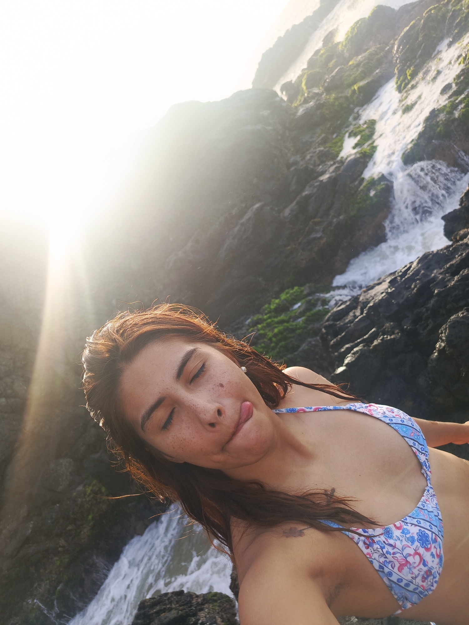 Beachgoers capture selfies on rocky Venezuelan coast during sunset