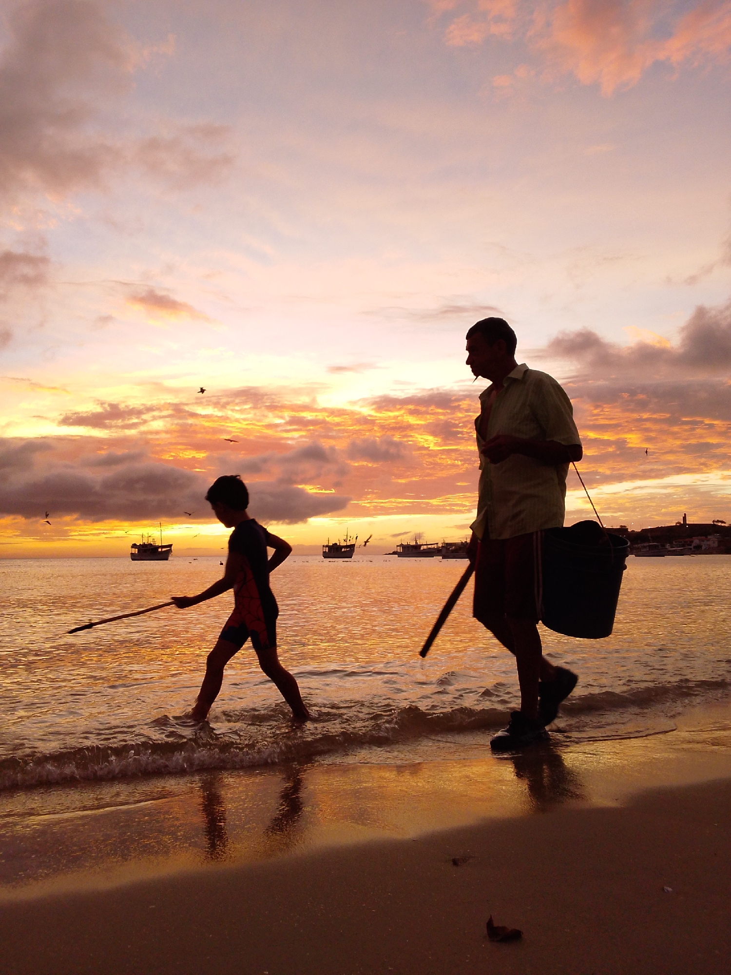 Coastal sunset gathering with pelicans, boats, traditional dancers witnessed