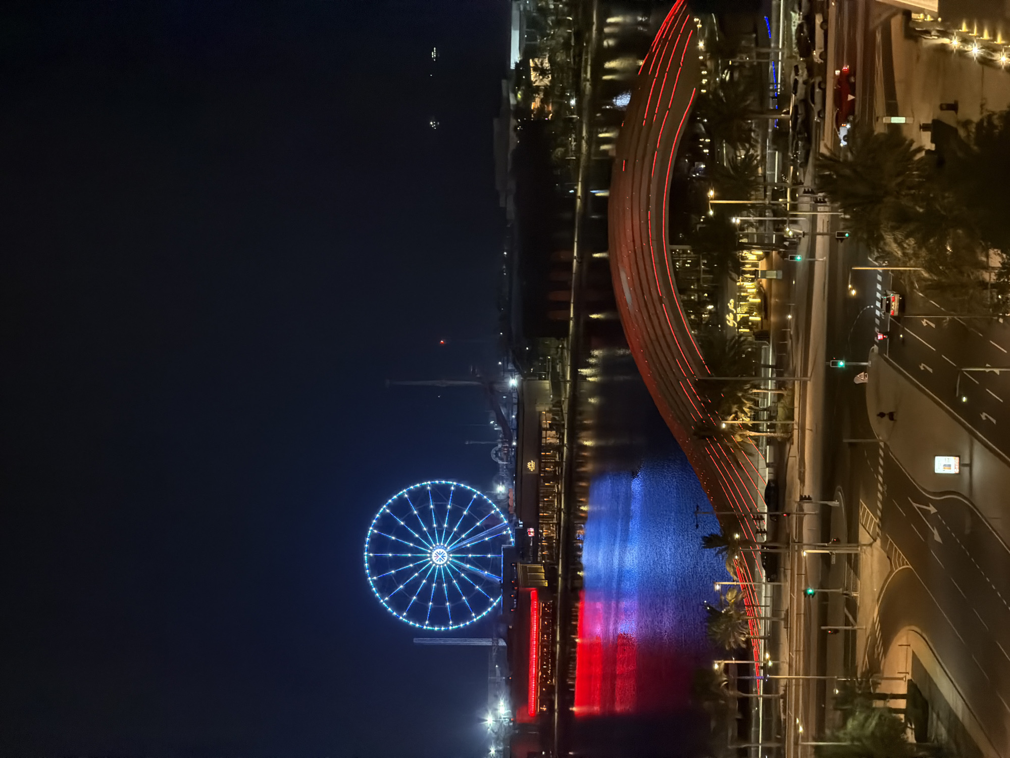 Nighttime aerial drift over a glittering waterfront city skyline