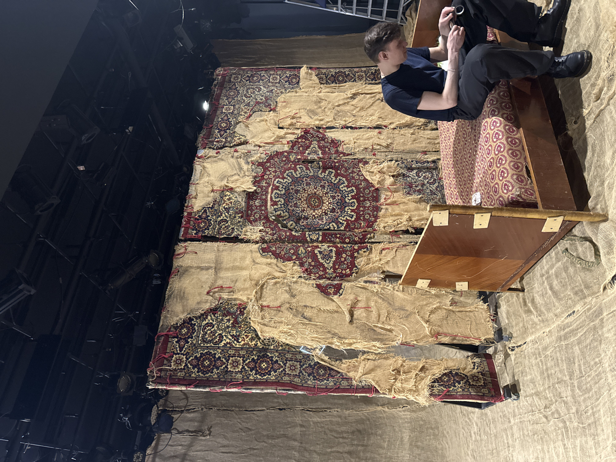 Man examines object while seated on furniture in Moscow