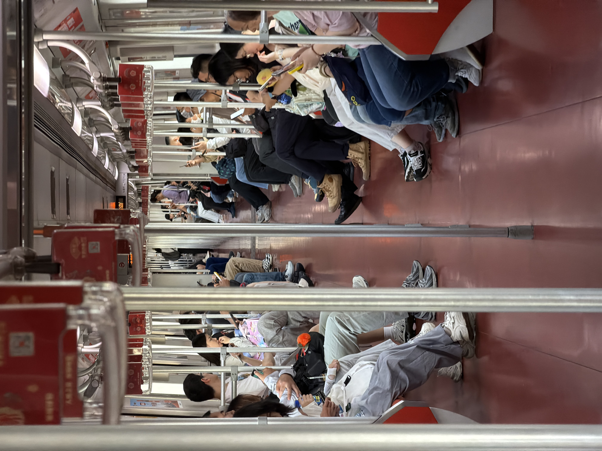 Pudong subway passengers absorbed in phones during morning commute