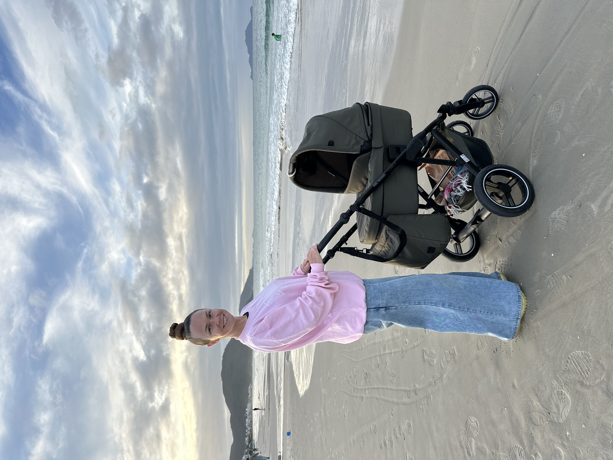 Woman with baby stroller enjoys beach day in Florianópolis