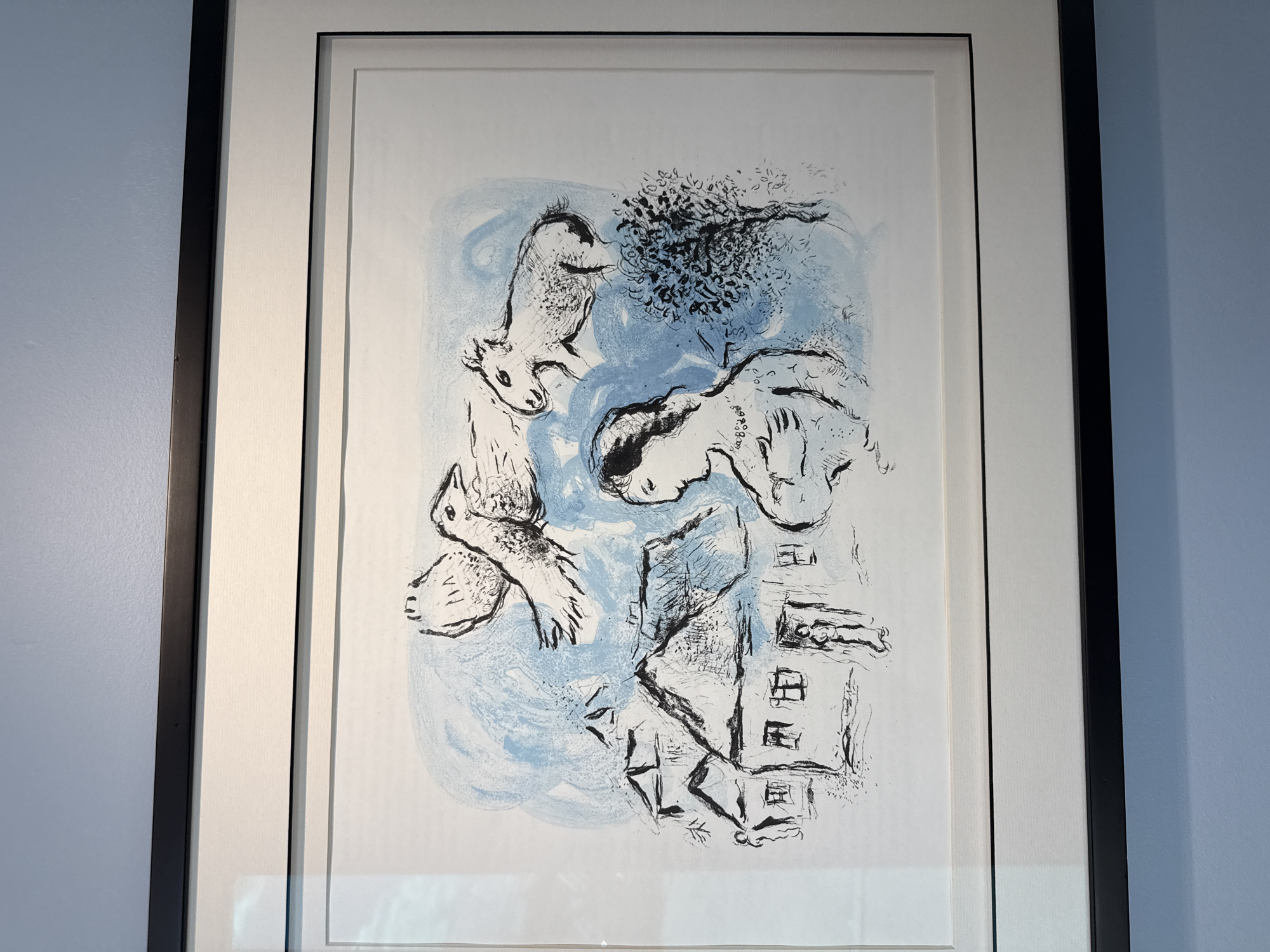 Gallery walls lined with surreal prints and Chagall lithographs