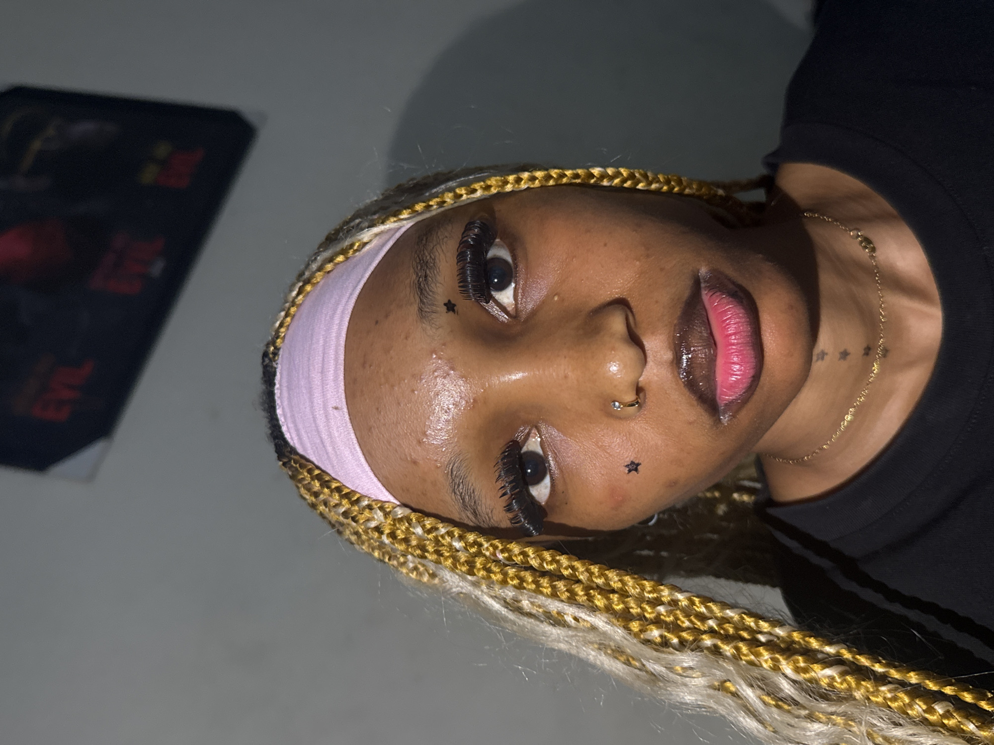 Bold beauty look with blonde braids and accessories in Ihiagwa