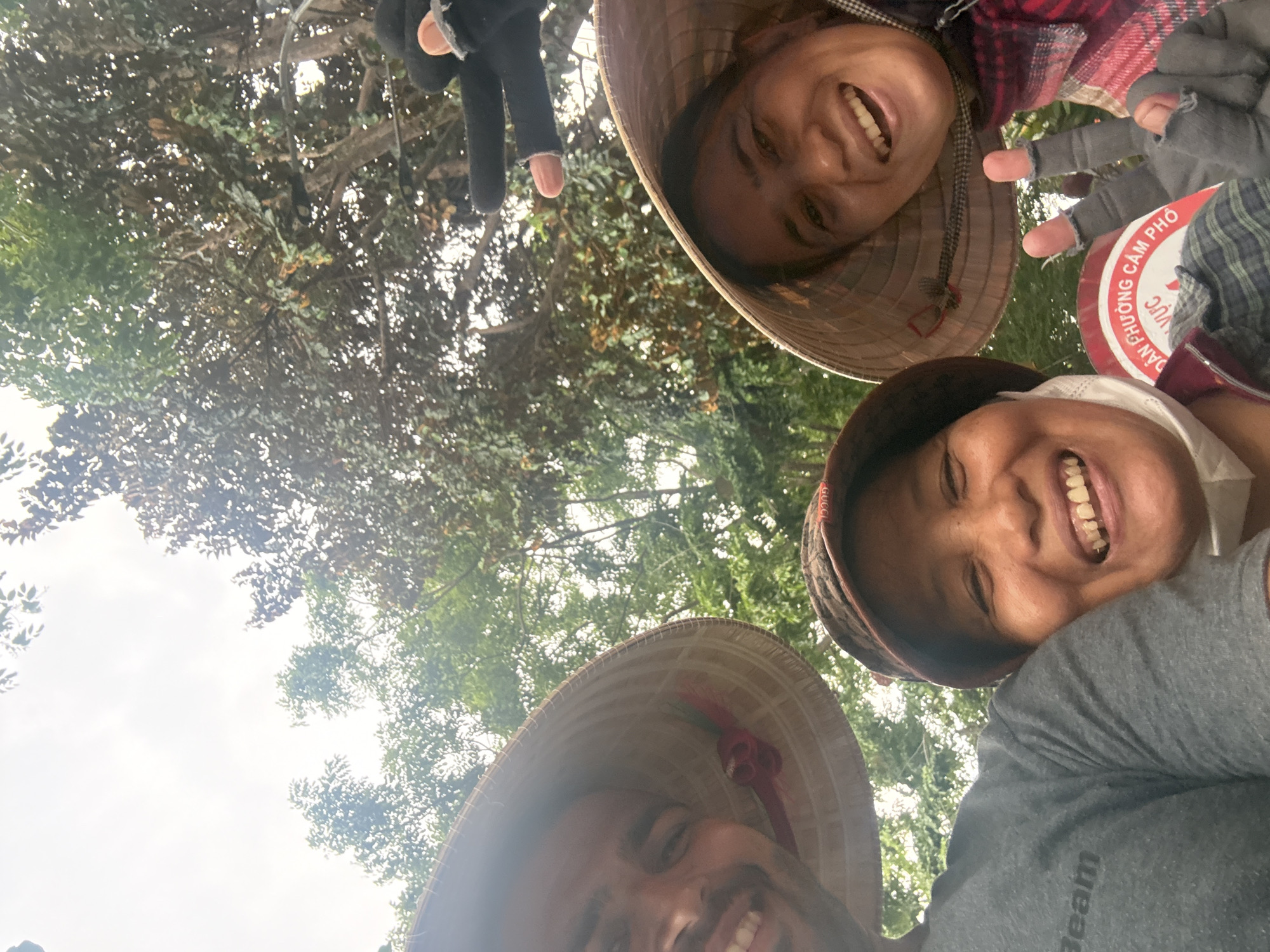 Tourists pose with traditional Vietnamese items in Hội An