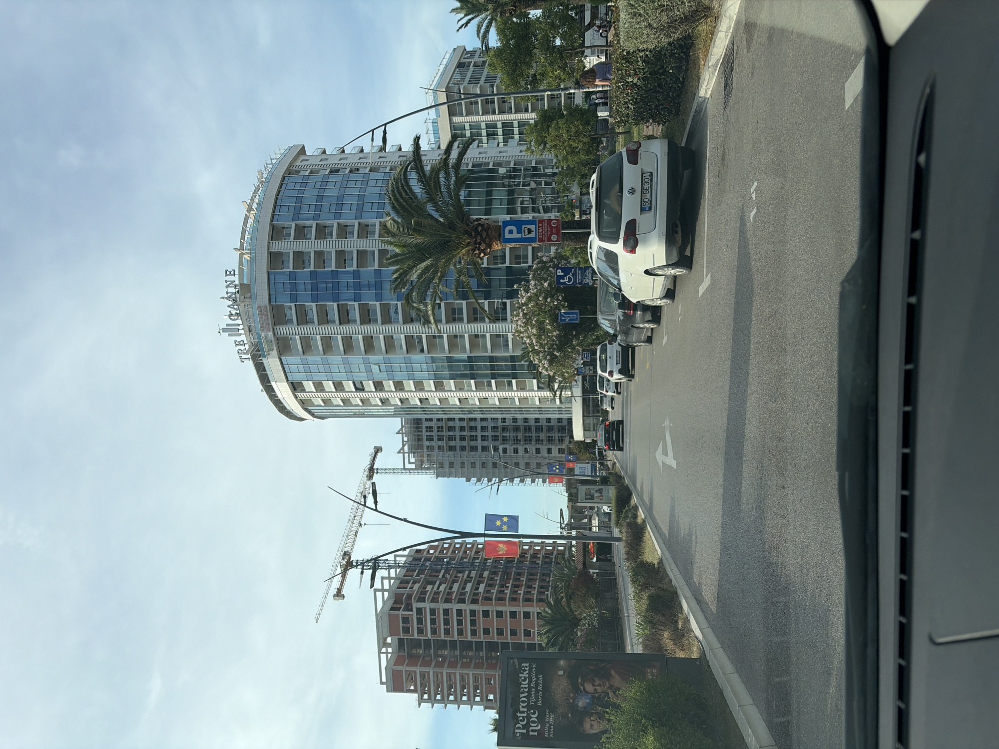 Morning observations capture Budva architecture and resident in car