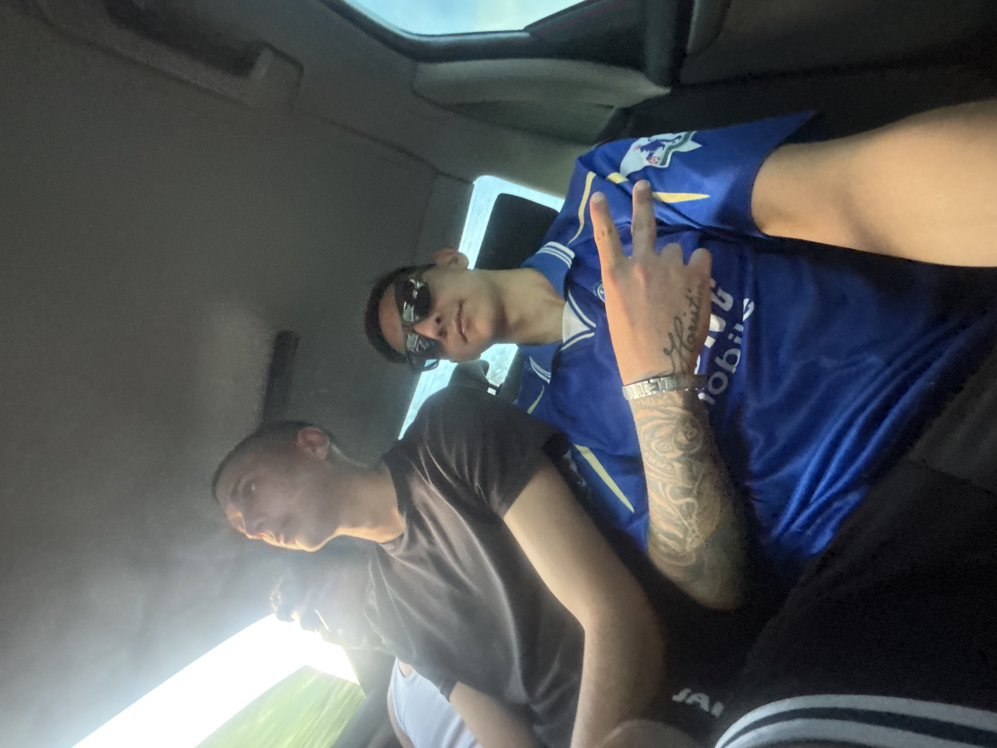 Three men spotted in vehicle, one flashing peace sign