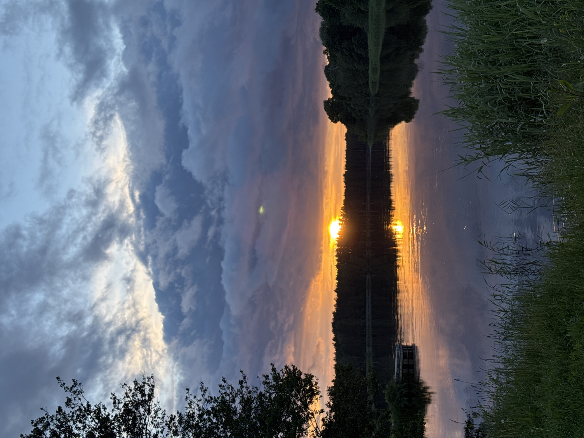 Sunset fades to twilight over calm water in Carnikava