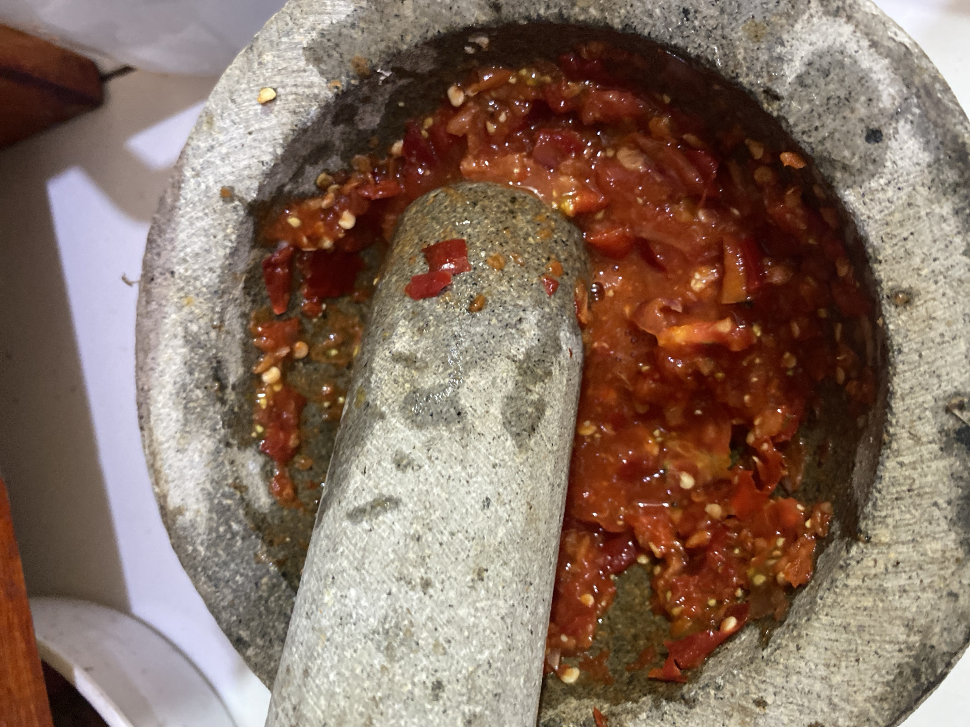 Late night food prep with chilies and corn in Ta', Indonesia